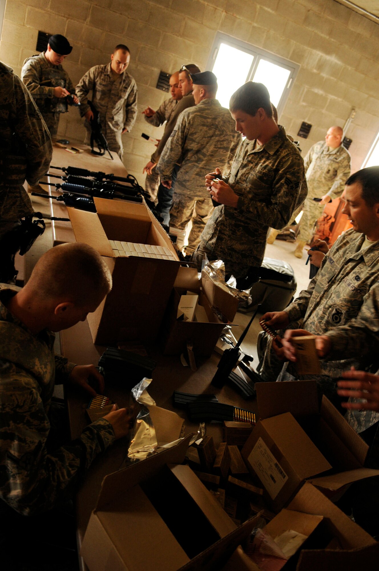 Airmen with the 354th Security Forces Squadron prepare their gear July 21, 2009, Fort Wainwright, Alaska. The squadron is participating in an exercise called Active Shooter to train Security Forces Airmen on how to neutralize threats within 90 seconds of entering the building. (U.S. Air Force photo/Airman 1st Class Laura Goodgame) 