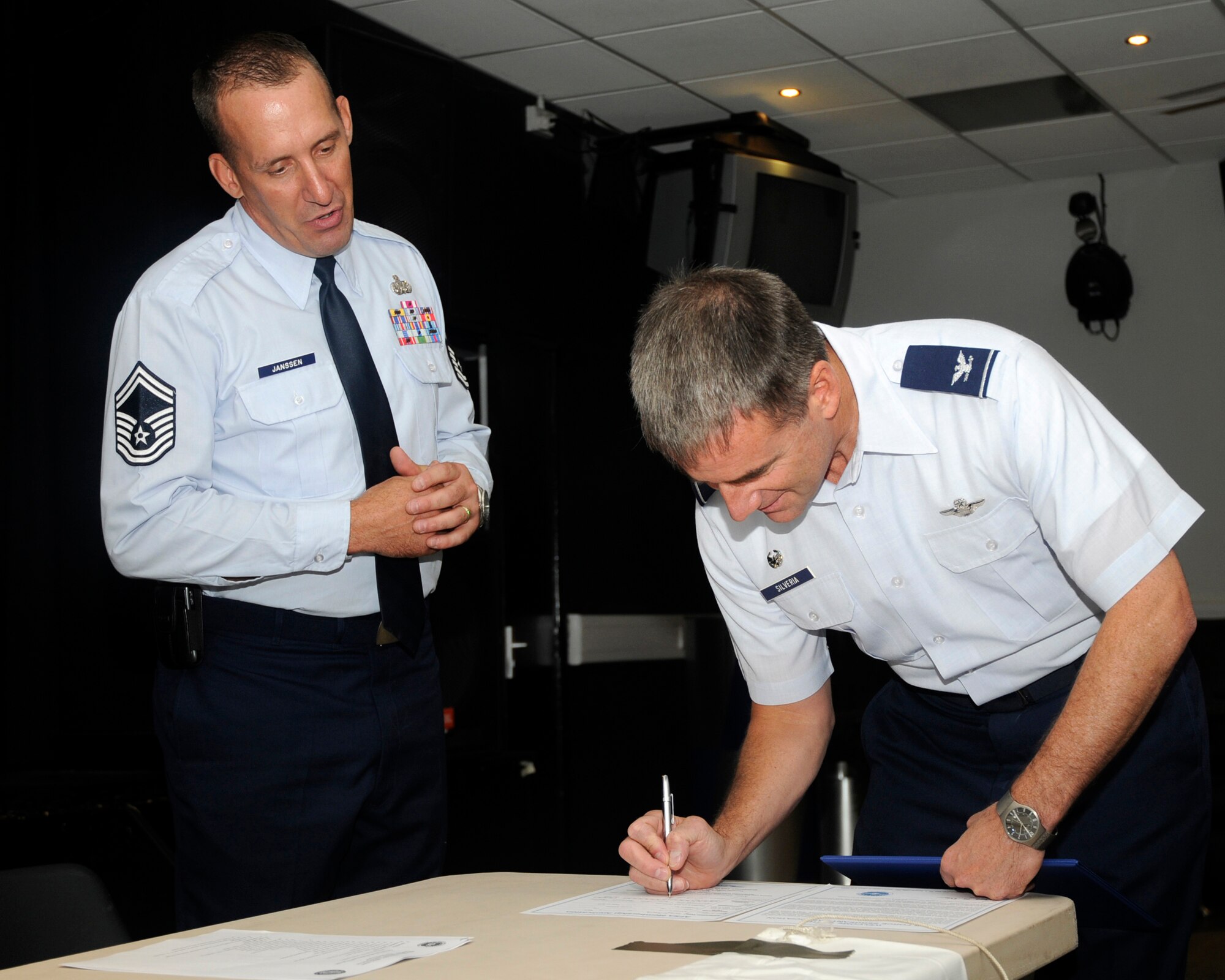 Senior Master Sgt. Daniel Janssen, president of the RAF Lakenheath Air Force Sergeants Association division, presents Col. Jay Silveria, 48th Fighter Wing commander, with a certificate of honorary membership to AFSA July 20, 2009, at RAF Lakenheath, England. AFSA is a private organization dedicated to helping Air Force members enhance their quality of life. (U.S. Air Force photo/Airman 1st Class Eboni Knox)