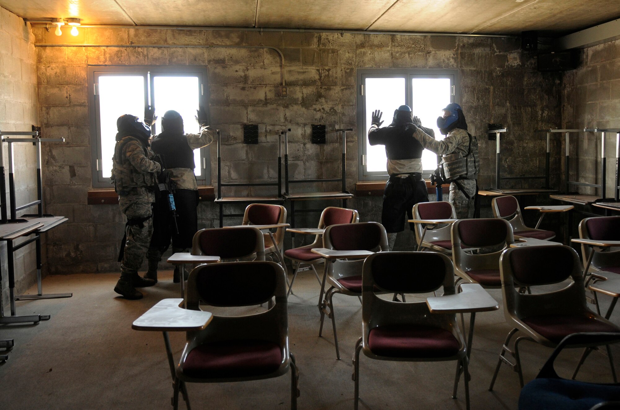 Airmen with the 354th Security Forces Squadron search hostages during an Active Shooter exercise July 21, 2009 Fort Wainwright, Alaska. The Airmen pracetice real life scenarios in order to be ready to neutralize the threat within 90 seconds of entering the building. (U.S. Air Force photo/Airman 1st Class Laura Goodgame)