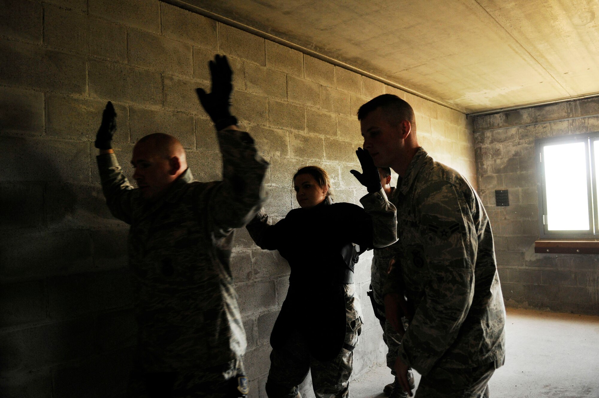 Airman 1st Class Zachary Bert commands the hostages to exit the building during an Active Shooter exercise July 21, 2009, Fort Wainwright, Alaska. The exercise builds confidence and communication skills amongst the Security Forces Airmen by training in real life scenarios. Airman Bert is with the 354th Security Forces Squadron. (U.S. Air Force photo/Airman 1st Class Laura Goodgame)