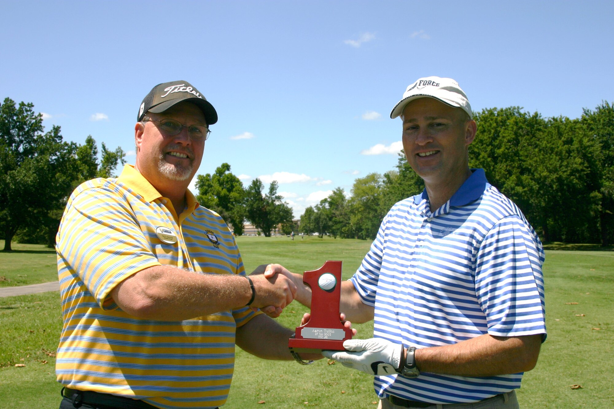 Jeff Slagle, Oklahoma City Air Logistics Center Staff Judge Advocate,  right, shot a hole-in-one on hole No. 8 at Tinker Golf Course on July 21. Dan Hayes, director of golf, presented a special trophy on the spot for such a feat that is the highlight in any golfer’s game. (Air Force photo by Kimberly Woodruff)
