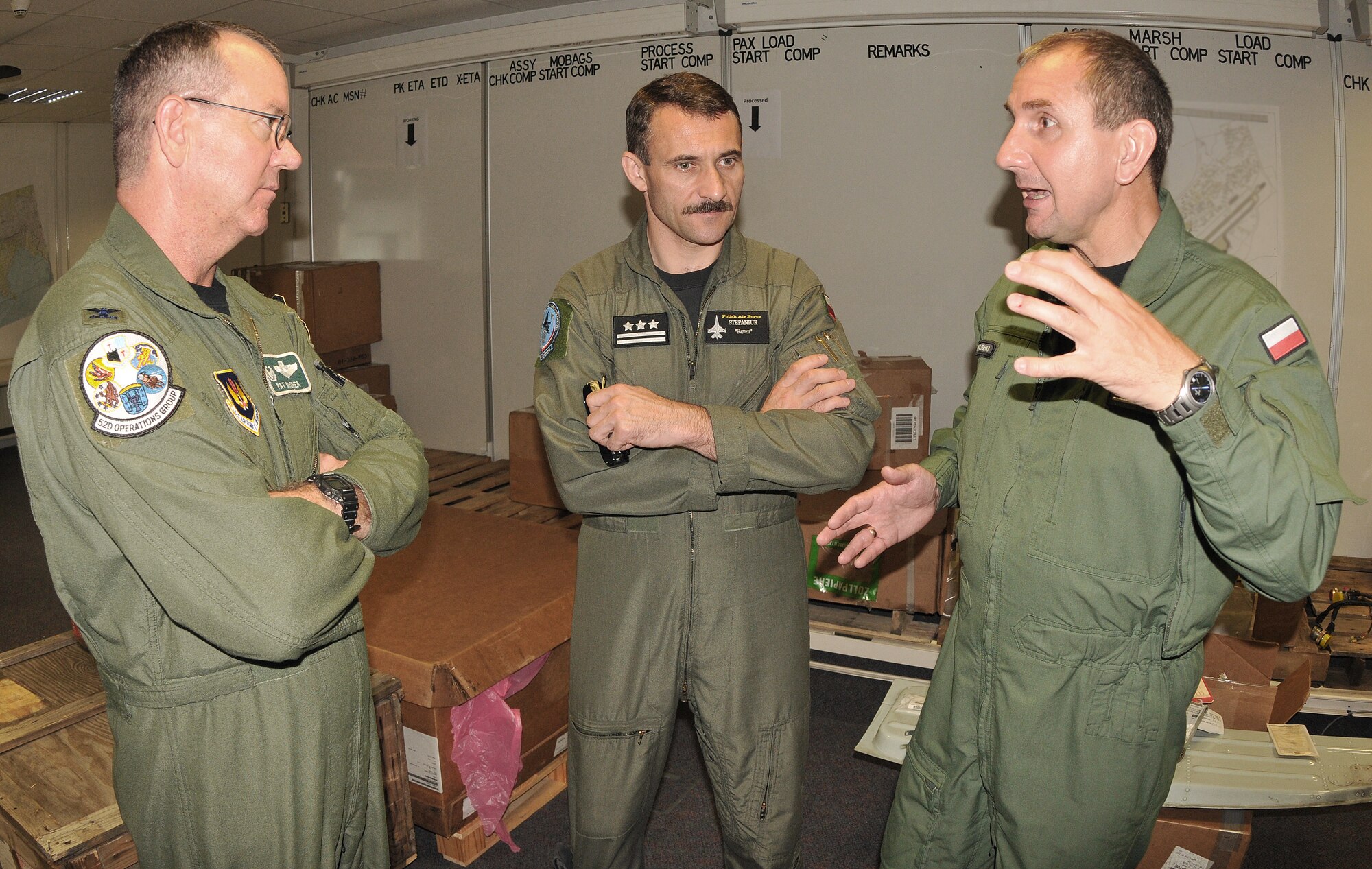 SPANGDAHLEM AIR BASE, Germany - Col. Ryszard Grzelinski (right), deputy chief of the Polish air force, and Col. Rocislaw Stepaniuk (middle), 31st Air Base commander, Krzesiny Air Base, Poland, discuss day-to-day operations of an American fighter squadron with Col. Patrick McCrea (left), 52nd Operations Group commander, during their visit to Spangdahlem Air Base July 29. Four Polish air force members visited Spangdahlem to observe the daily routine and operations tempo of an American F-16 Fighting Falcon squadron and an American Air Base. (U.S. Air Force photo by Airman 1st Class Nick Wilson)