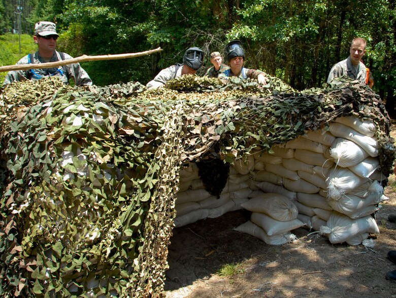 New second lieutenants attending Maxwell's Air and Space Basic Course are shown in different phases of field training on Lake Jordan as part of Vigilant Warrior. Learning the skills to operate in an expeditionary environment, they are armed with "simulated M-4 marker sets," or paint guns and learn land navigation, small unit tactics and integrated base defense. (U.S. Air Force photo/Donna Burnett)