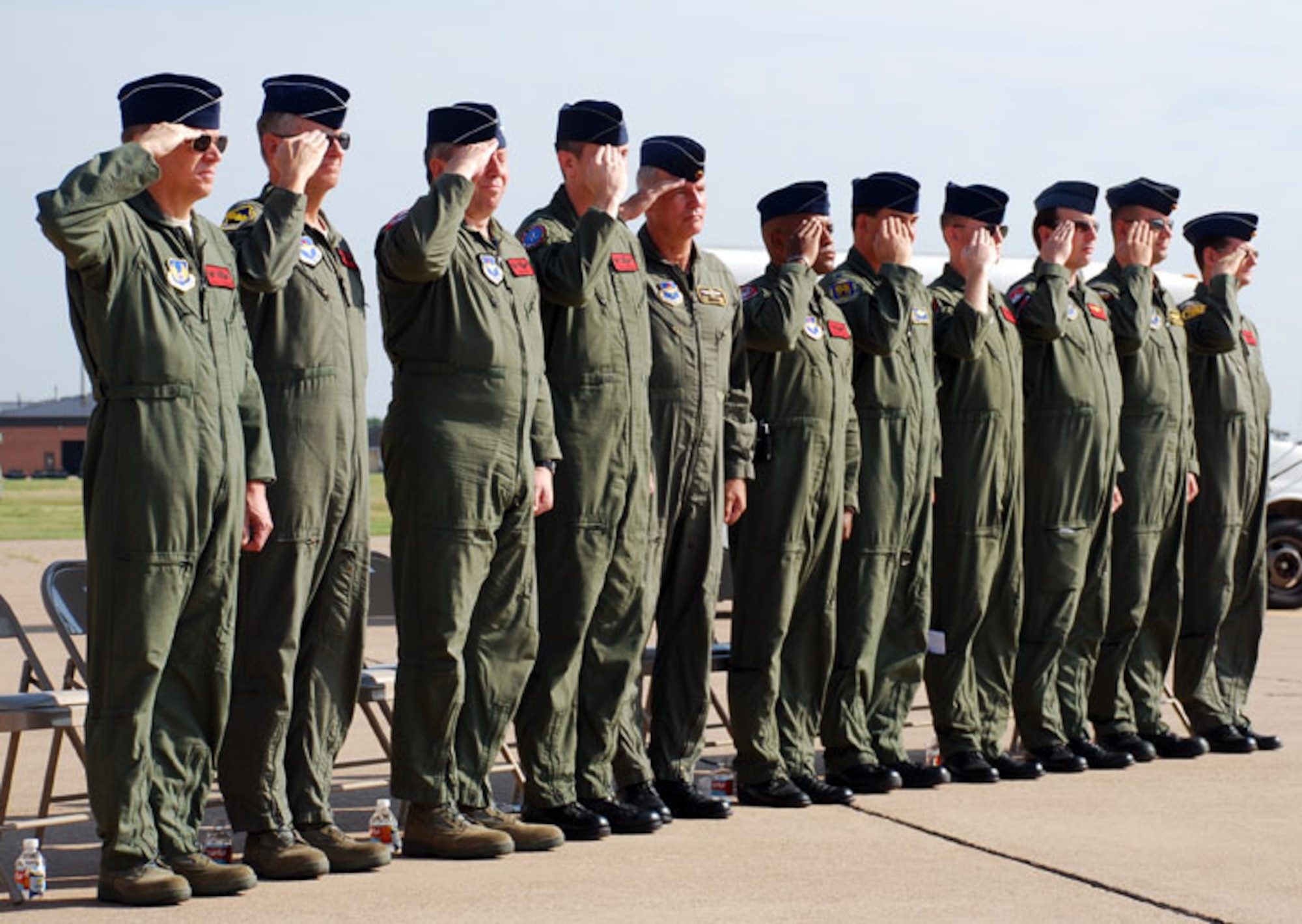Pilots from the 89th Flying Training Squadron honor the U.S. flag July 31 at the beginning of the T-37 Tweet retirement ceremony. The Tweet served the Air Force for more than 50 years as the introductory platform for pilot training. The T-6A Texan II will replace the venerable Tweet. (U.S. Air Force photo/Airman 1st Class Adawn Kelsey)