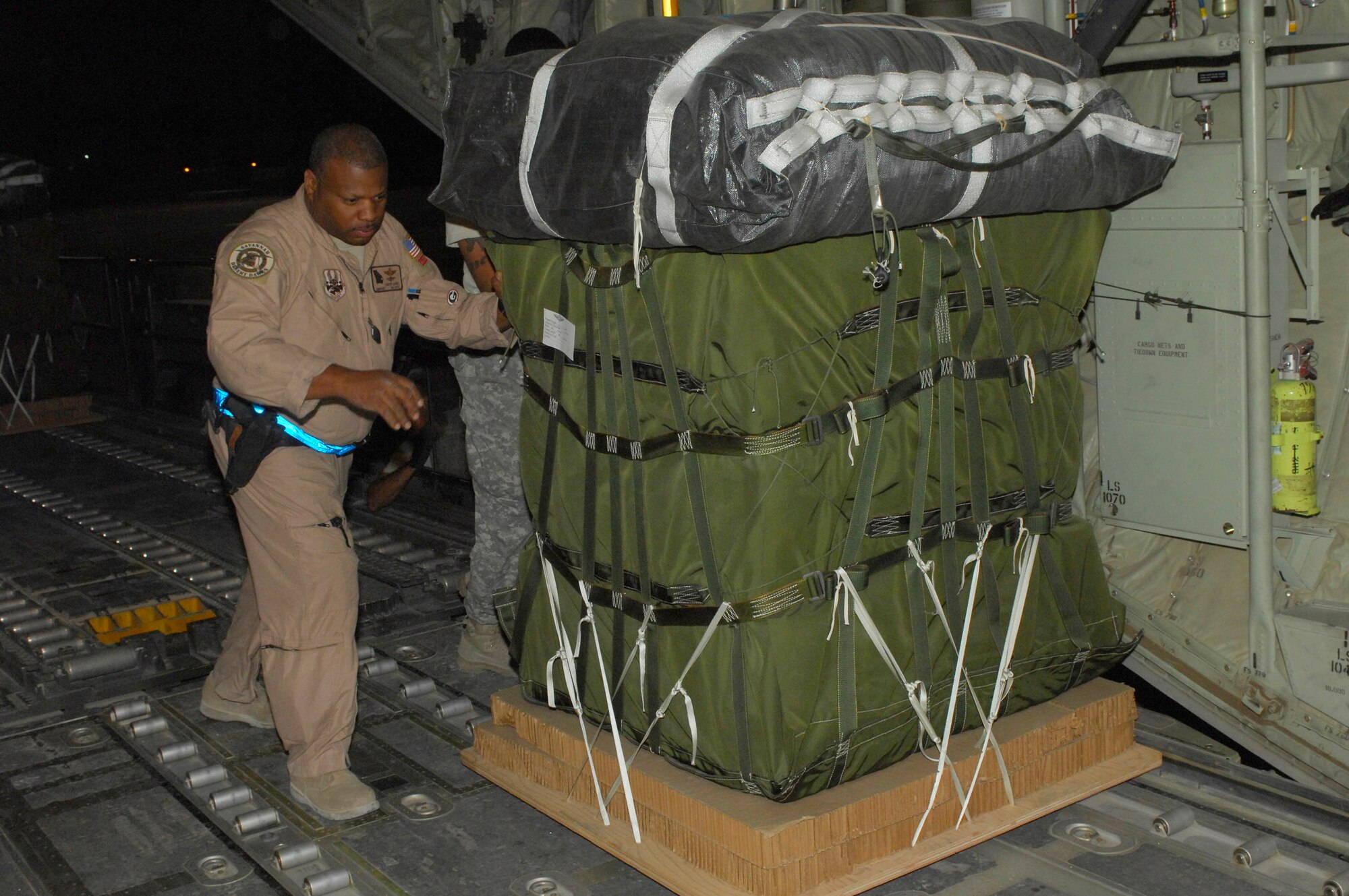 BAGRAM AIRFIELD, Afghanistan - Senior Master Sgt. Timothy Gaines, 165th Airlift Wing, Georgia Air National Guard moves a pallet onto a C-130 Hercules cargo bay. The pallet was part of an airdrop supply mission. Sergeant Gaines' unit is deployed from Savannah Ga., which is also his homeown. (U.S. Air Force photo/Tech. Sgt. John Jung)