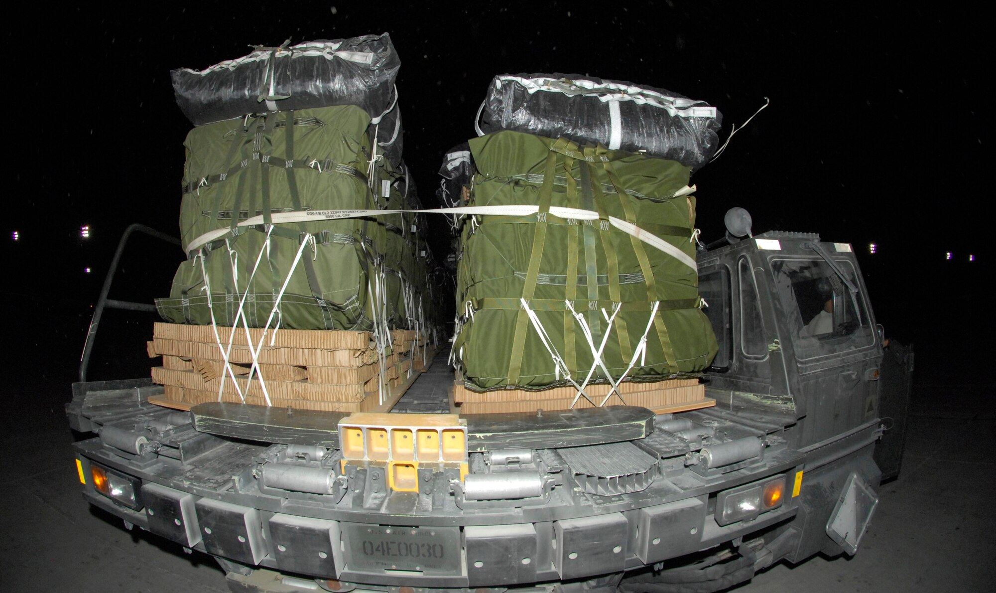 BAGRAM AIRFIELD, Afghanistan - A 60K loader moves pallets towards a C-130 Hercules. The pallets were being loaded onto the Hercules for an airdrop mission. The Hercules and the 60K loader are both workhorses here at Bagram Airfield. (U.S. Air Force photo/Tech. Sgt. John Jung)