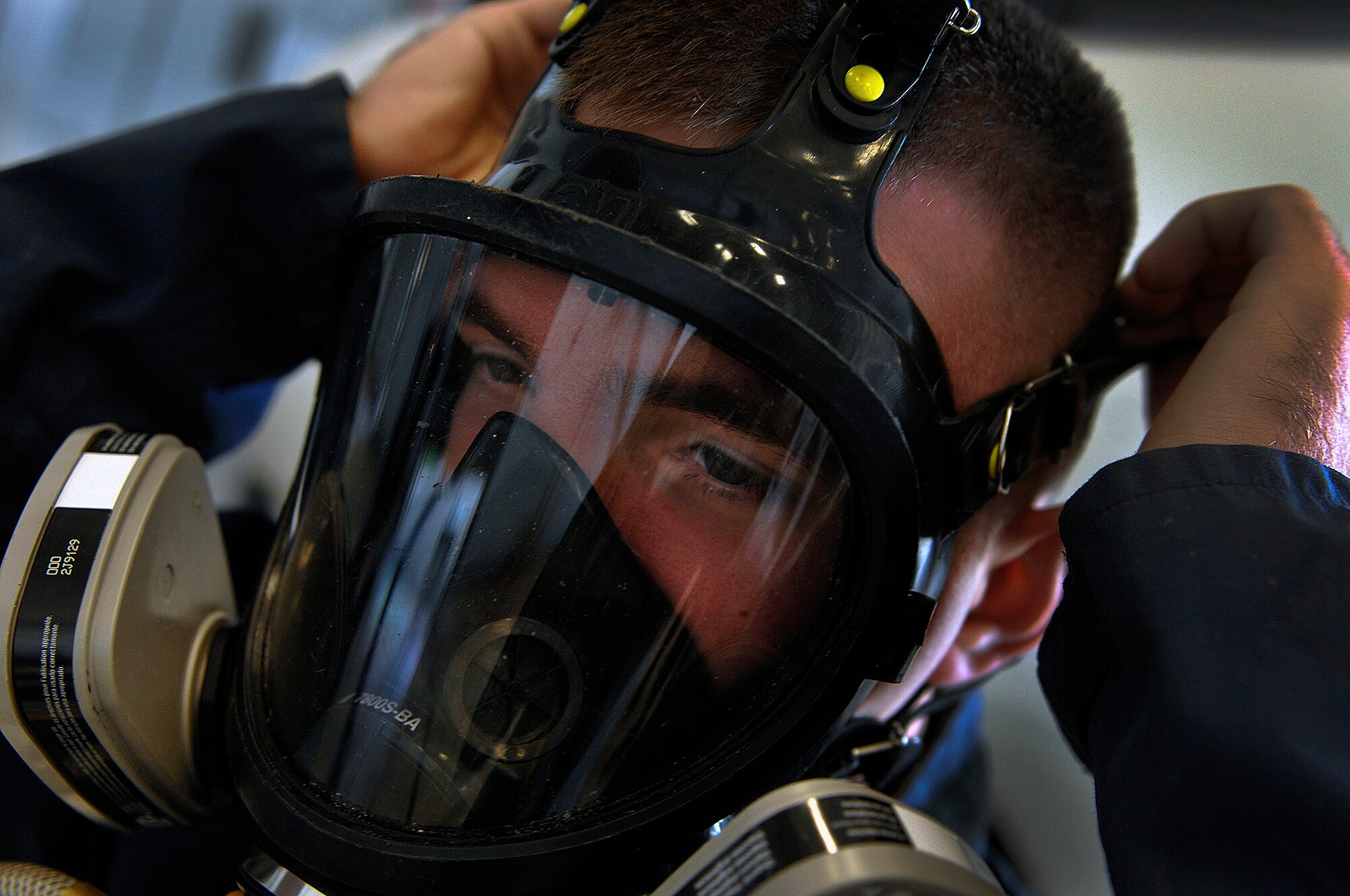 Airman 1st Class Dustin Roy, 28th Maintenance Squadron aircraft fuels systems repair apprentice, fits a full faced air supply respirator to his head before a fuel tank extraction exercise here, July 30. The exercise was performed to practice emergency response techniques for work inside a fuel tank. (U.S. Air Force photo/Airman 1st Class Joshua J. Seybert)