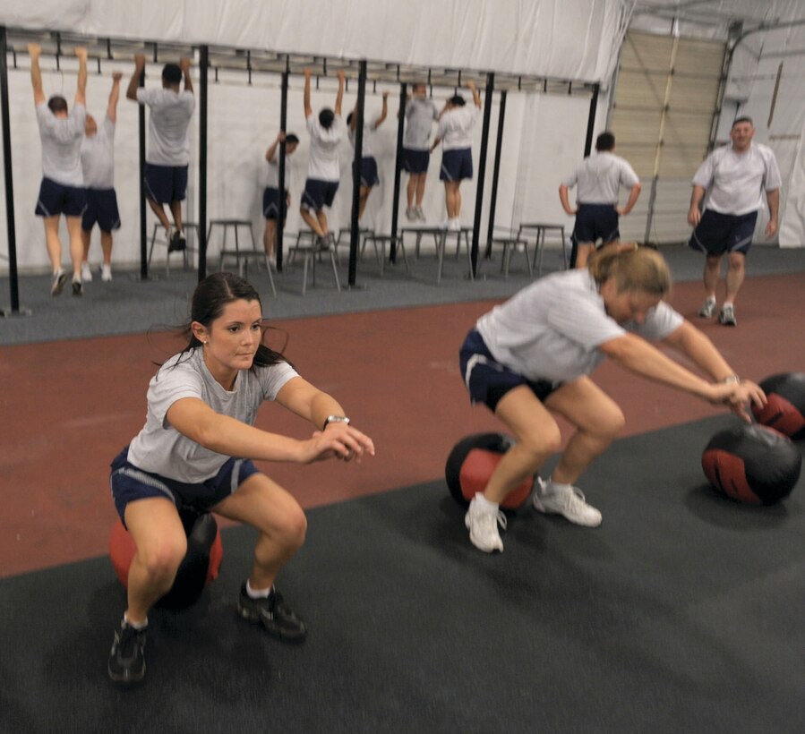 Second Lt. Sheriden Martinez, 316th Comptroller Squadron financial management officer, performs body squats during a Cross-Fit workout in the Tactical Ffitness Center here Wednesday. Cross-Fit is a core strength and conditioning program designed to optimize physical competence in ten recognized fitness domains of cardiovascular and respiratory endurance, stamina, strength, flexibility, power, speed, coordination, agility, balance, and accuracy. (U.S. Air Force photo/ Senior Airman Steven Doty)