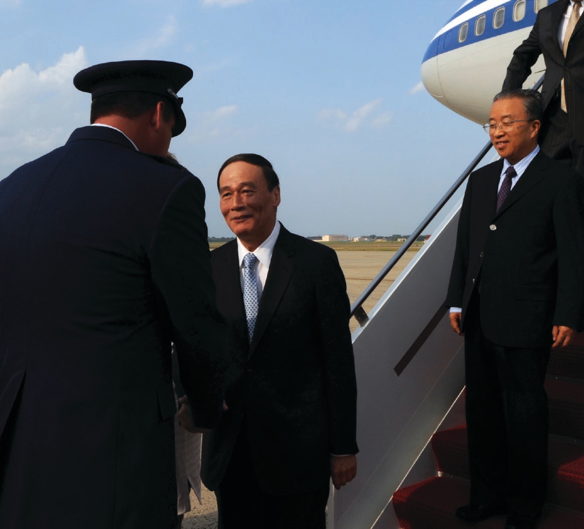 Colonel Lee DePalo, 316th Wing/Andrews vice commander, greets China’s Vice Premier Wang Qishan and State Councilor Dai Bingguo upon their arrival at Andrews Saturday. The Chinese delegation is here to attend the first round of the China-U.S. Strategic and Economic dialogues. (U.S. Air Force photo/ Airman 1st Class Melissa Rodrigues)