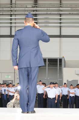 U.S. Air Force Col. Mark Dillon salutes the members of the 86th Airlift Wing on Ramstein Air Base for the first time as the new wing commander. Colonel Dillon assumed command from Brig. Gen. William Bender on July 31, 2009. (U.S. Air force photo By: Tech. Sgt. Sean Mateo White) 