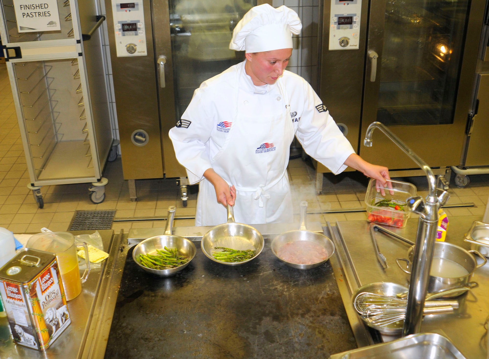 U.S. Air Force Senior Airmen Sheryl Stewart, 86th Services Squadron, food service journeyman saut?s asparagus during the U.S. Air Forces in Europe Top Chef Competition at the Lindberg Hof Dining Facility on Kapaun Air Station July 30, 2009. (U.S. Air Force photo by Tech. Sgt. Kenneth Bellard)