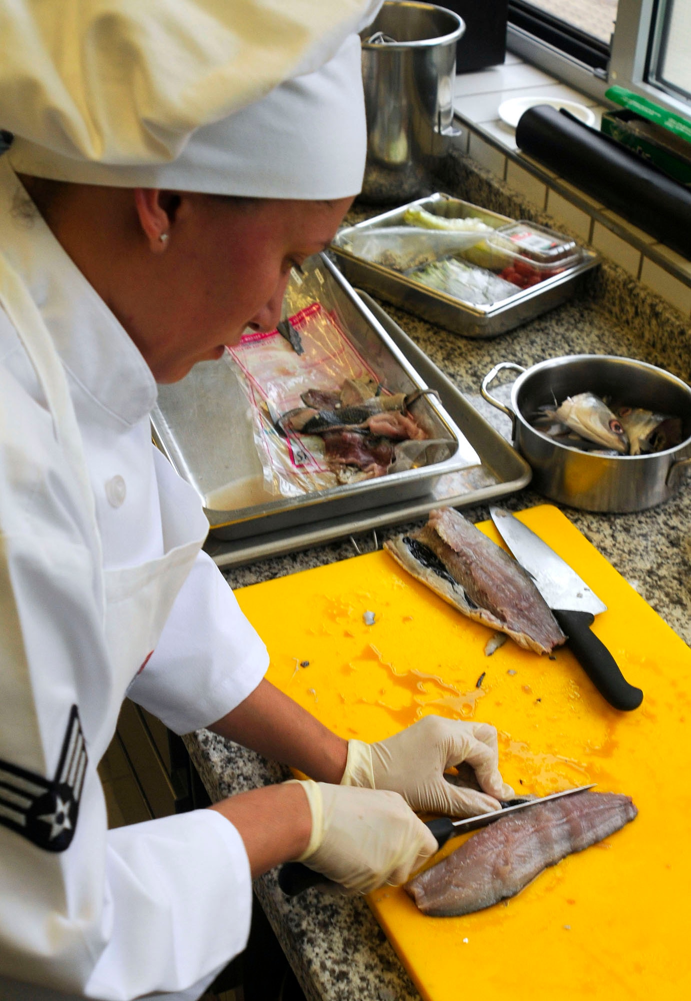 U.S. Air Force Senior Airmen Sheryl Stewart, 86th Services Squadron, food service journeyman prepares her main dish during the U.S. Air Forces in Europe Top Chef Competition at the Lindberg Hof Dining Facility on Kapaun Air Station July 30, 2009. (U.S. Air Force photo by Tech. Sgt. Kenneth Bellard)