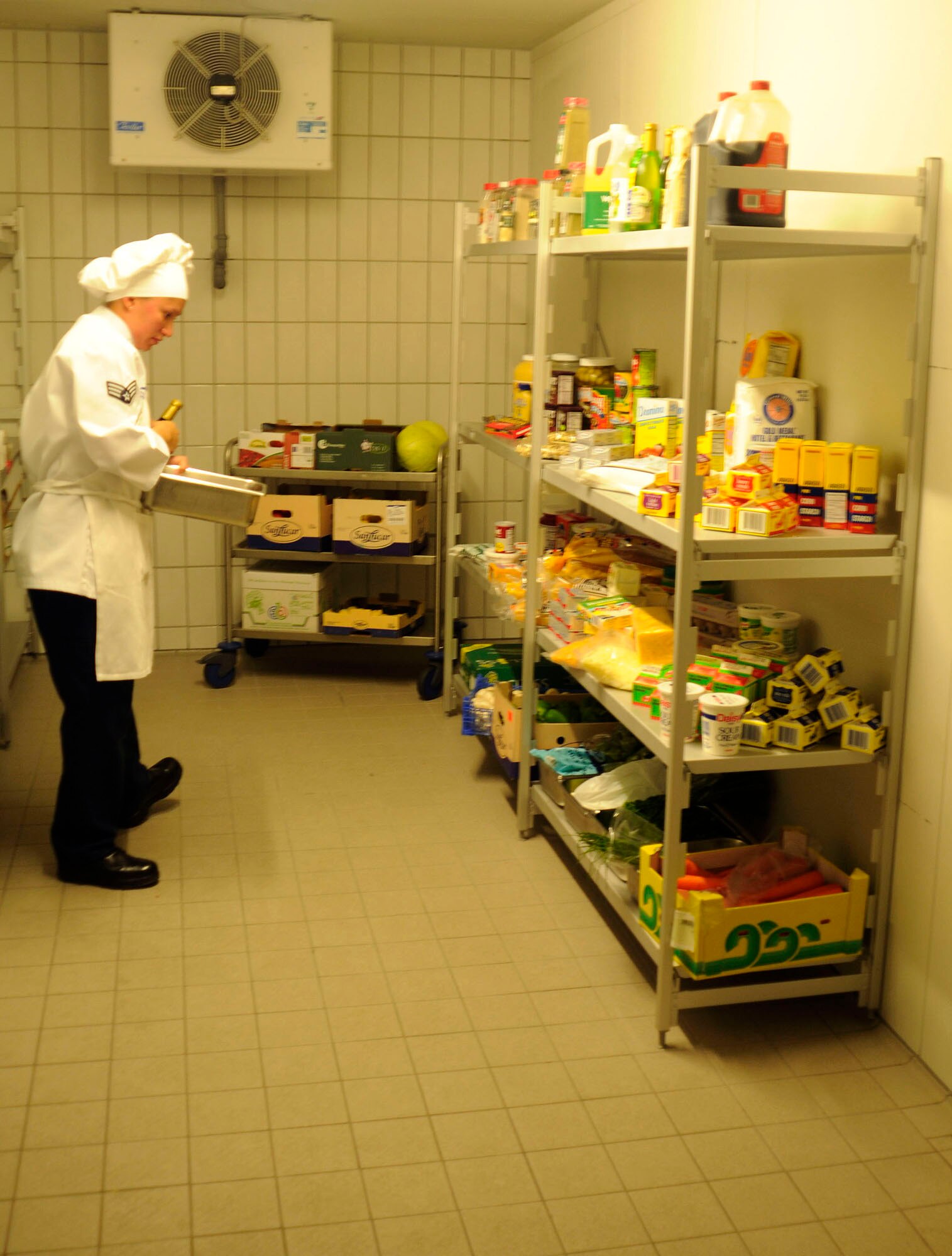 U.S. Air Force Senior Airmen Sheryl Stewart, 86th Services Squadron, food service journeyman searches for different ingredients to prepare her dish during the U.S. Air Forces in Europe Top Chef Competition at the Lindberg Hof Dining Facility on Kapaun Air Station July 30, 2009. (U.S. Air Force photo by Tech. Sgt. Kenneth Bellard)