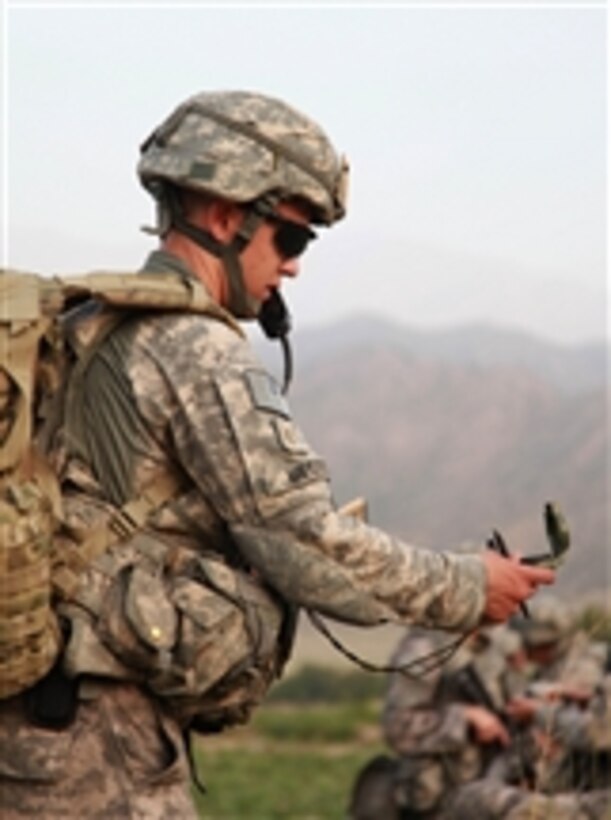 U.S. Army 2nd Lt. Matthew Meggs checks his compass to be sure of his unit’s direction of travel during an air-assault mission in the Khost province of Afghanistan on July 28, 2009.  Meggs is from Headquarters and Headquarters Company, 2nd Battalion, 377th Parachute Field Artillery Regiment, 4th Brigade Combat Team, 25th Infantry Division.  
