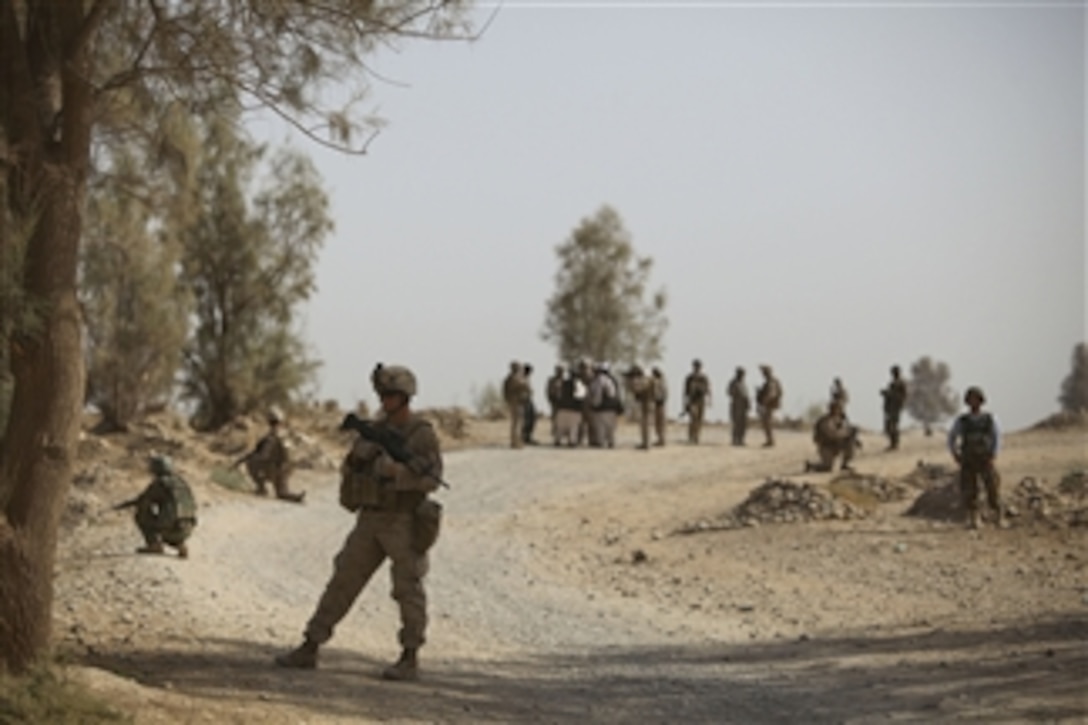 Afghan soldiers and U.S. Marines with 1st Battalion, 5th Marine Regiment conduct a road reconnaissance patrol in Nawa District, Helmand province, Afghanistan, on July 25, 2009.  U.S. Marines with 1st Battalion, 5th Marine Regiment, Regimental Combat Team 3, 2nd Marine Expeditionary Brigade -Afghanistan are deployed in support of NATO's International Security Assistance Force and will participate in counter insurgency operations and the training and mentoring of Afghan security forces.  
