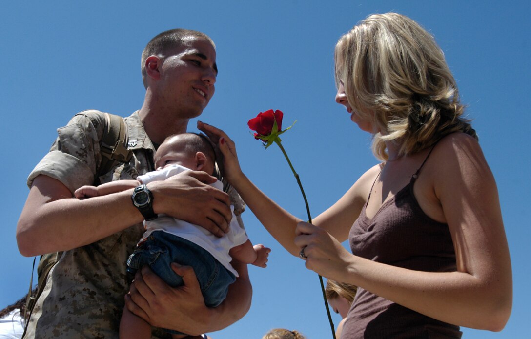 Sgt. Daniel A. Arcuri holds his infant son Noah for the first time after returning home to his wife Rachelle at the Marine Corps Air Station in Yuma, Ariz., July 31, 2009, from a seven-month deployment at sea with the 13th Marine Expeditionary Unit. Four-month-old Noah was born midway through the deployment. A detachment of approximately 100 Marines and six AV-8B Harrier jets from Marine Attack Squadron 214 and Marine Aviation Logistics Squadron 13 set sail Jan. 9, 2009, from San Diego aboard the USS Boxer. The highlight of the deployment was the MEU's participation in counter-piracy operations off the coast of Africa near Somalia in the Gulf of Aden. The VMA-214 pilots used the Harriers for surveillance and reconnaissance, according to Capt. Michael Maddock, pilot. The aircraft's targeting pod cameras enabled pilots to gather valuable imagery of suspected pirate vessels. Arcuri, a 22-year-old native of Tacoma, Wash., served as the VMA-214 embarkation chief during the deployment. The remainder of VMA-214 is currently deployed to Afghanistan. The last time VMA-214 served with a Marine expeditionary unit was in 2007 when the Black Sheep traveled to Japan to link up with the 31st MEU.