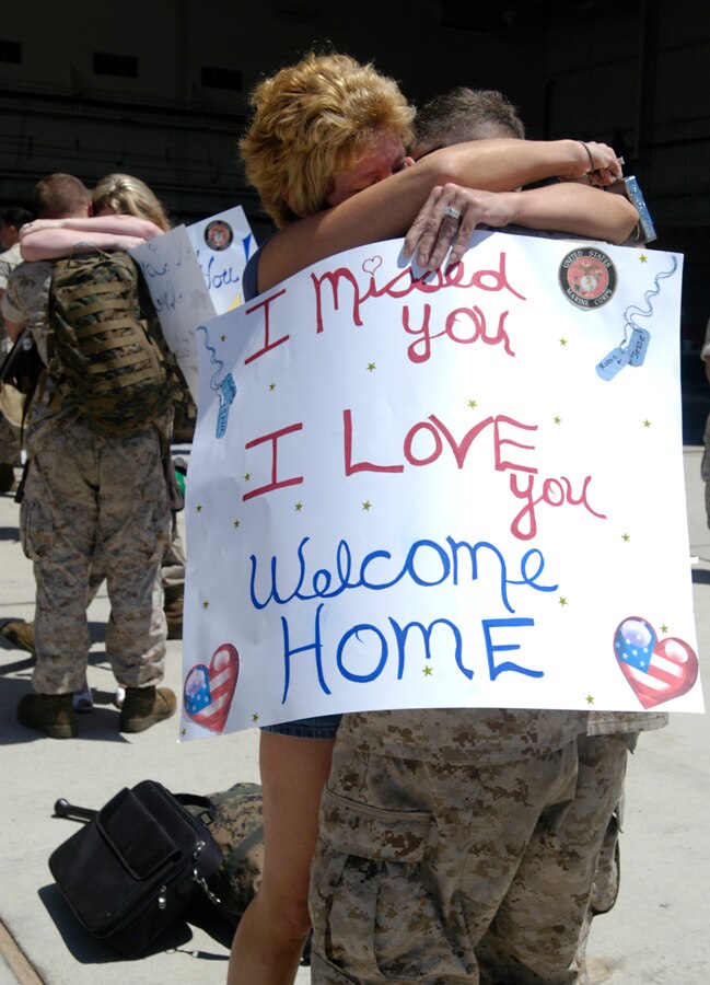 Reunited couples embrace after Marines based at the Marine Corps Air Station in Yuma, Ariz., return home July 31, 2009, from a seven-month deployment at sea with the 13th Marine Expeditionary Unit. A detachment of approximately 100 Marines and six AV-8B Harrier jets from Marine Attack Squadron 214 and Marine Aviation Logistics Squadron 13 set sail Jan. 9, 2009, from San Diego aboard the USS Boxer. The highlight of the deployment was the MEU's participation in counter-piracy operations off the coast of Africa near Somalia in the Gulf of Aden. The VMA-214 pilots used the Harriers for surveillance and reconnaissance, according to Capt. Michael Maddock, pilot. The aircraft's targeting pod cameras enabled pilots to gather valuable imagery of suspected pirate vessels. The remainder of VMA-214 is currently deployed to Afghanistan. The last time VMA-214 served with a Marine expeditionary unit was in 2007 when the Black Sheep traveled to Japan to link up with the 31st MEU.