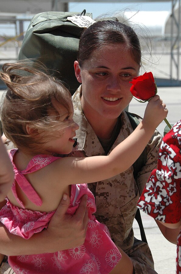 Sgt. Alica Keppley, Marine Aviation Logistics Squadron 13 aviation supply specialist, holds her daughter Arrianna, 2, after returning home to the Marine Corps Air Station in Yuma, Ariz., from a seven-month deployment with the 13th Marine Expeditionary Unit aboard the USS Boxer July 31, 2009. Approximately 100 Marine Attack Squadron 214 and MALS-13 Marines and sailors returned to Yuma. While deployed, the Marines aided in counter-piracy operations off the coast of Africa, near the Gulf of Aden, including the recovery of Richard Phillips, a civilian cargo ship captain who was taken hostage by Somali pirates.