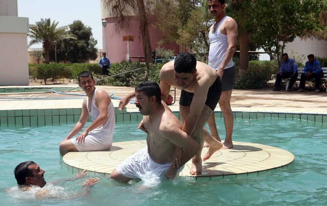 A group of local Iraqis enjoy the new pool at the Habbaniyah Tourist Village. Funding provided by the Marines and Coalition forces has helped improvements such as a new pool and restaurant to be opened. (U.S. Marine Corps photograph by Cpl. Bobbie A. Curtis)