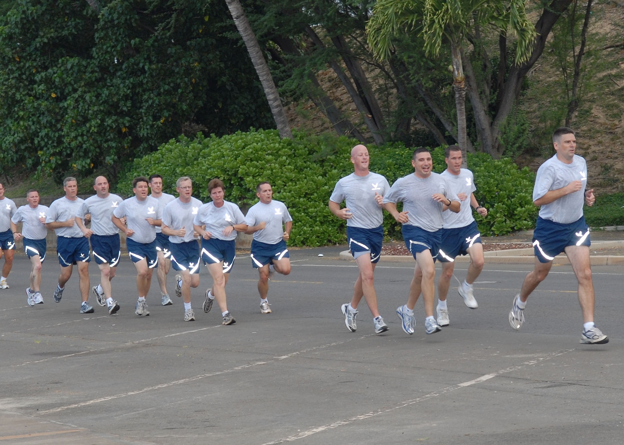 Members of Pacific Air Forces’ A-staff run in formation at Hickam Air Force Base, Hawaii, May 27 during a morning “beach PT session.”  Approximately 70 people participated in the physical training session, which included a 1.5-mile run to Hickam Beach, a half-hour session of calisthenics and team building, followed by a 1.5-mile run back to the starting point. The directorates participating in the beach session were A3, A4, A5 and A8. (U.S. Air Force photo/Tech. Sgt. Jerome Tayborn)