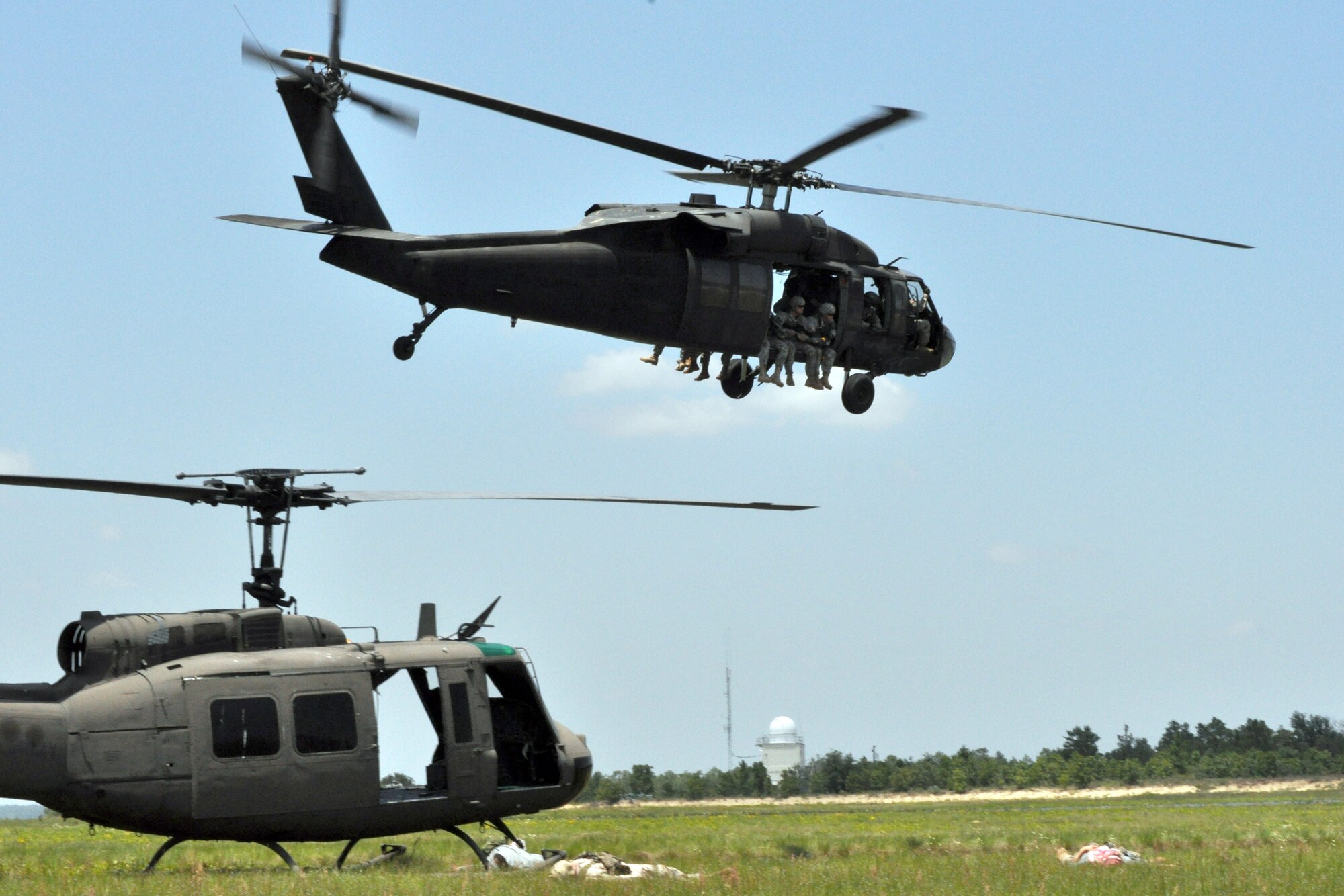 EGLIN AIR FORCE BASE, Fla. – Soldiers demonstrate a simulated assault on enemies guarding a downed helicopter during the Army’s 6th Ranger Training Battalion open house May 30. The event was a chance for the public to witness how they train and operate in extreme situations. The event included a variety of displays such as dive equipment, weapons, and zodiac boats. Demonstrations featured at the event included hand-to-hand combat demonstration, parachute jump, and an urban operations demonstration. (U.S. Air Force photo/ Airman Anthony Jennings)