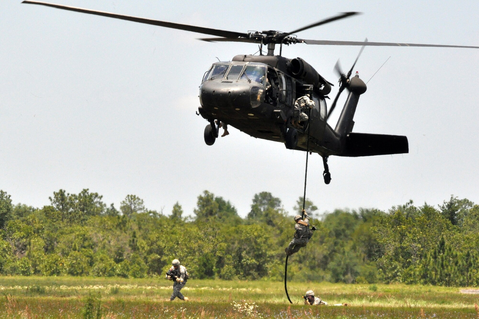 EGLIN AIR FORCE BASE, Fla. – Soldiers demonstrate a simulated assault on enemies guarding a downed helicopter during the Army’s 6th Ranger Training Battalion open house May 30. The event was a chance for the public to witness how they train and operate in extreme situations. The event included a variety of displays such as dive equipment, weapons, and zodiac boats. Demonstrations featured at the event included hand-to-hand combat demonstration, parachute jump, and an urban operations demonstration. (U.S. Air Force photo/ Airman Anthony Jennings)
