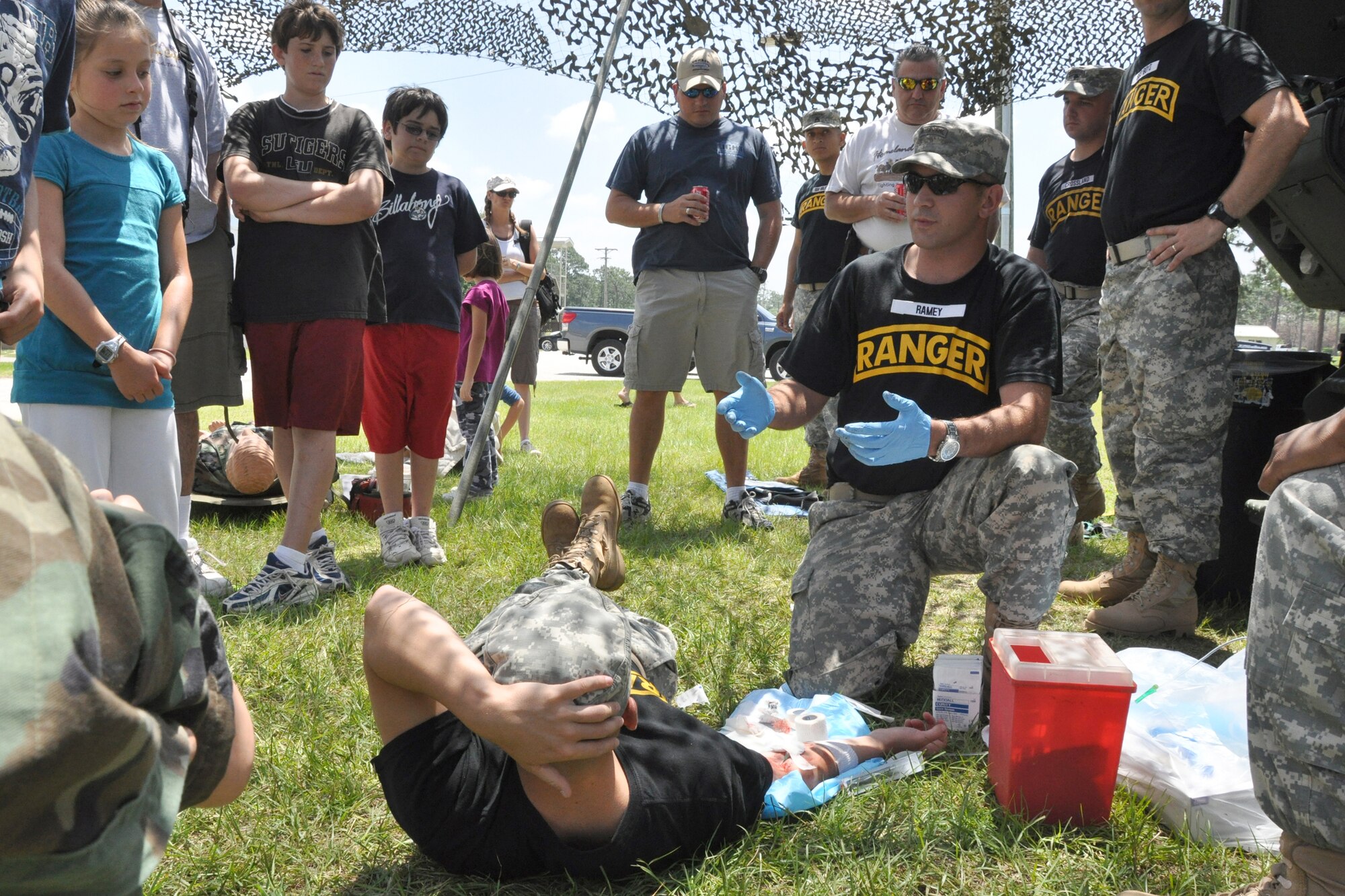 EGLIN AIR FORCE BASE, Fla. – Soldiers demonstrate self-aid buddy care during the Army’s 6th Ranger Training Battalion open house May 30. The event was a chance for the public to witness how they train and operate in extreme situations. The event included a variety of displays such as dive equipment, weapons, and zodiac boats. Demonstrations featured at the event included hand-to-hand combat demonstration, parachute jump, and an urban operations demonstration. (U.S. Air Force photo/ Airman Anthony Jennings)