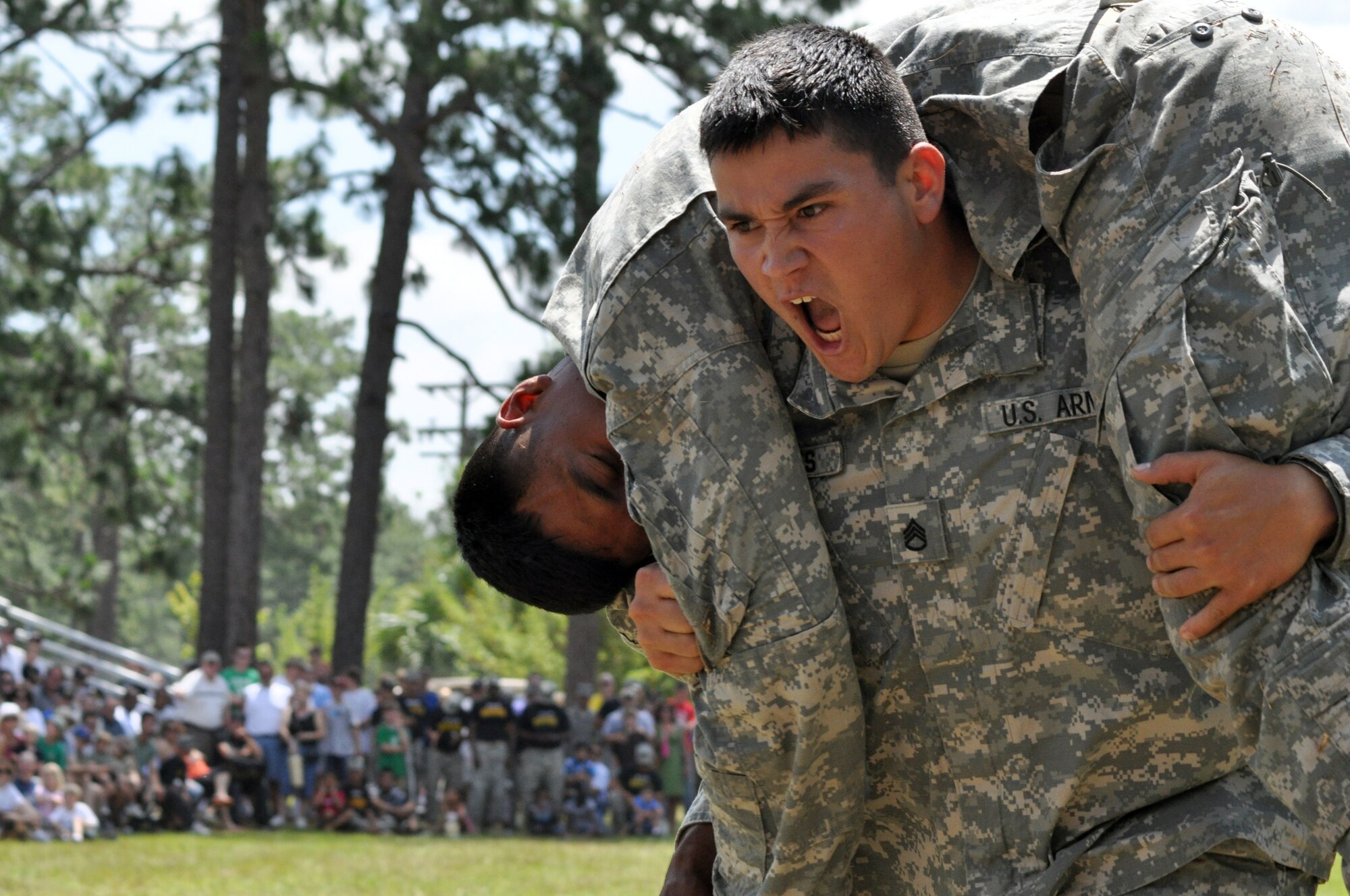 EGLIN AIR FORCE BASE, Fla. – A soldier demonstrates an over-the-shoulder carry during a demo at the Army’s 6th Ranger Training Battalion open house May 30. The event was a chance for the public to witness how they train and operate in extreme situations. The event included a variety of displays such as dive equipment, weapons, and zodiac boats. Demonstrations featured at the event included hand-to-hand combat demonstration, parachute jump, and an urban operations demonstration. (U.S. Air Force photo/ Airman Anthony Jennings)