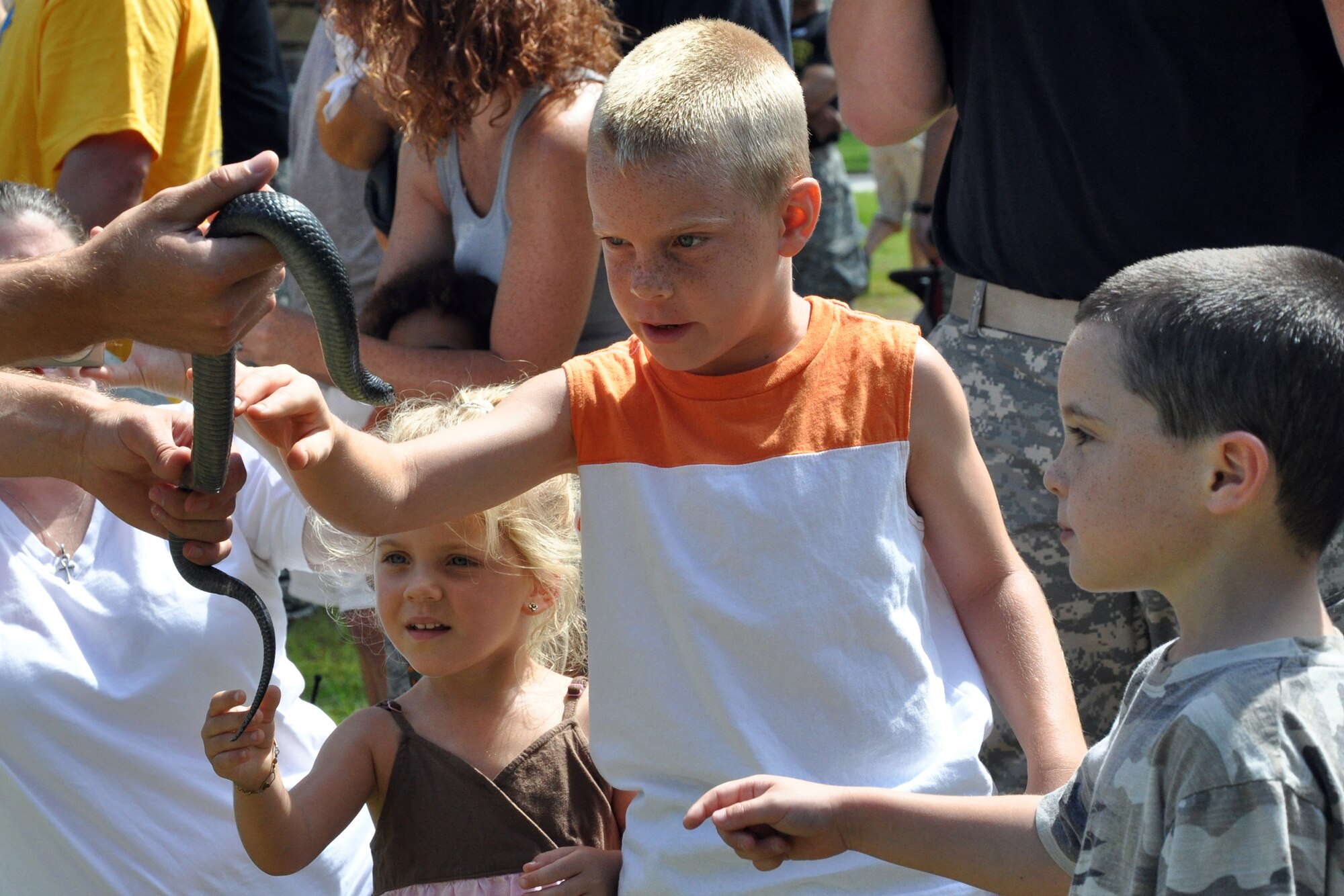 EGLIN AIR FORCE BASE, Fla. – Children get a hands-on experience with live snakes and other reptiles during a demonstration of the Army’s 6th Ranger Training Battalion hosted an open house May 30. The event was a chance for the public to witness how they train and operate in extreme situations. The event included a variety of displays such as dive equipment, weapons, and zodiac boats. Demonstrations featured at the event included hand-to-hand combat demonstration, parachute jump, and an urban operations demonstration. (U.S. Air Force photo/ Airman Anthony Jennings)