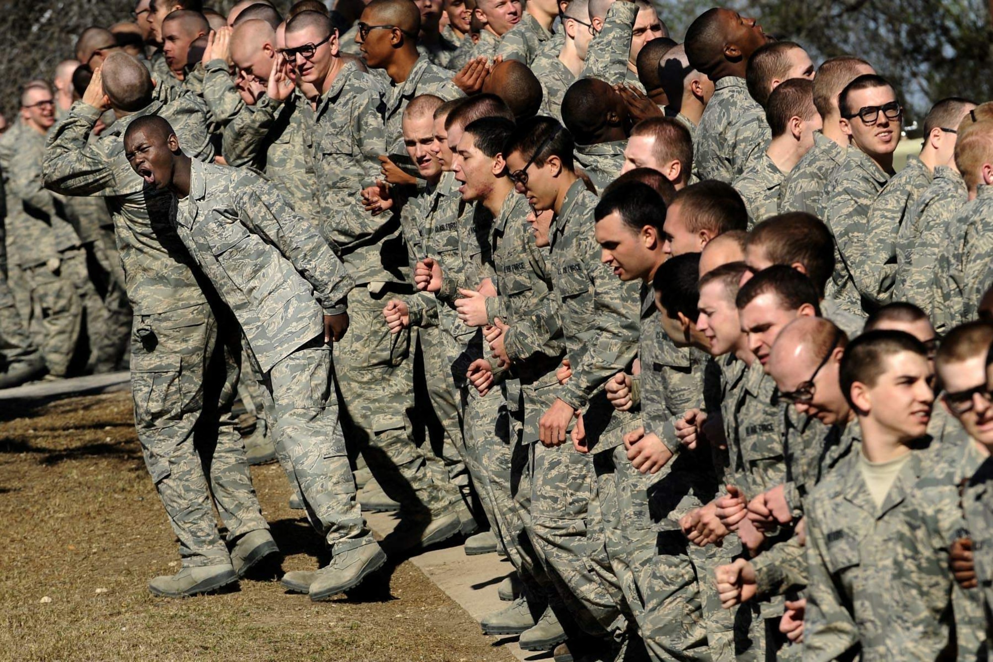 Basic trainees rally themselves with motivational chants while waiting to navigate the obstacle course at Lackland Air Force Base, Texas.  (U.S. Air Force photo/Master Sgt. Cecilio Ricardo)
