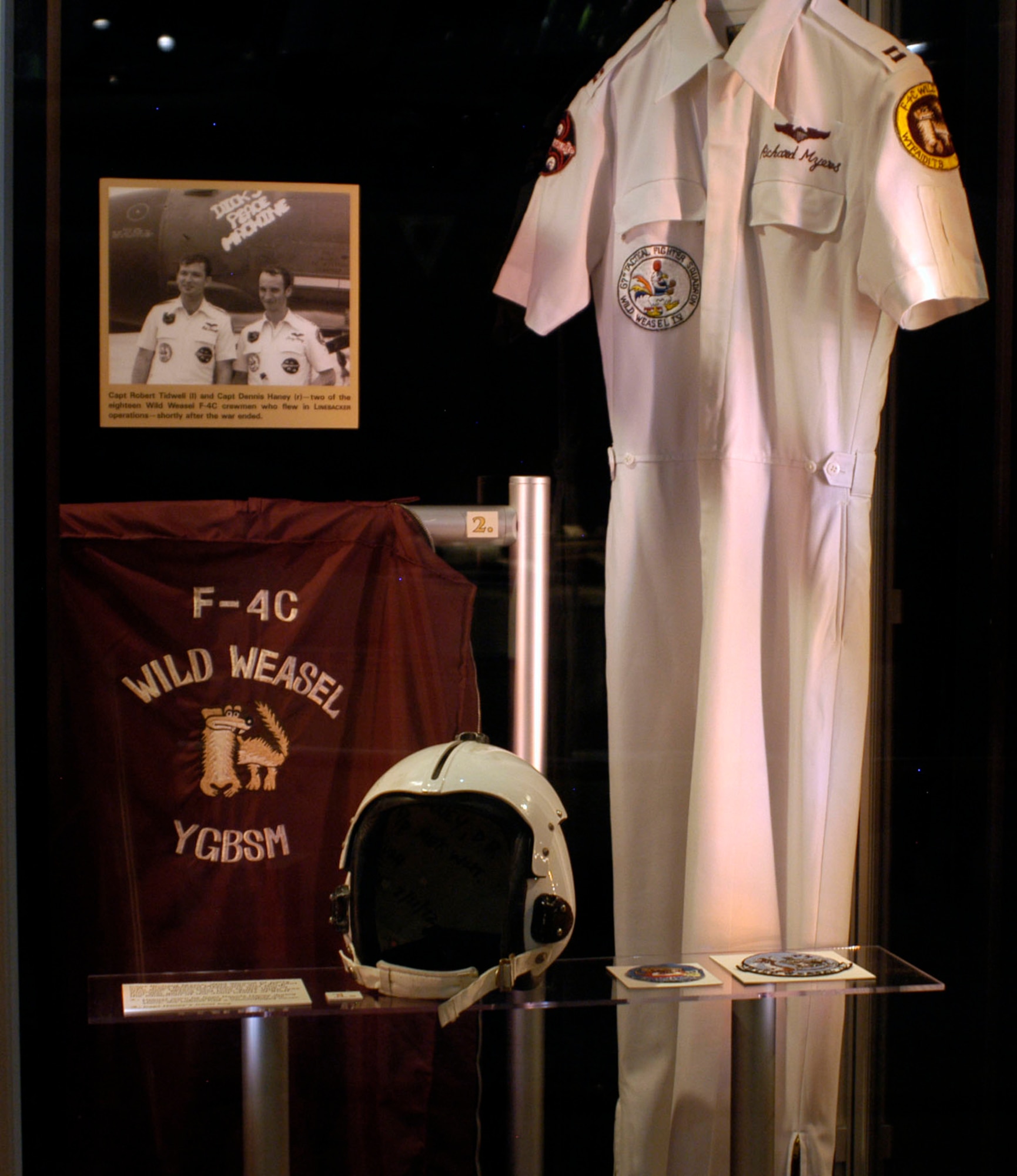 DAYTON, Ohio - Capt. Richard Myers' Wild Weasel IV party suit. Capt. Myers was an F-4C pilot who flew Linebacker missions over North Vietnam. Myers later rose to the rank of four star general, and from 2001-2005 was the Chairman of the Joint Chiefs of Staff. Also in the exhibit case is a helmet worn by Capt. Dennis Haney during Linebacker operations. On combat missions, the helmet had a camouflaged cover. And, Capt. Haney's travel bag. (U.S. Air Force photo)