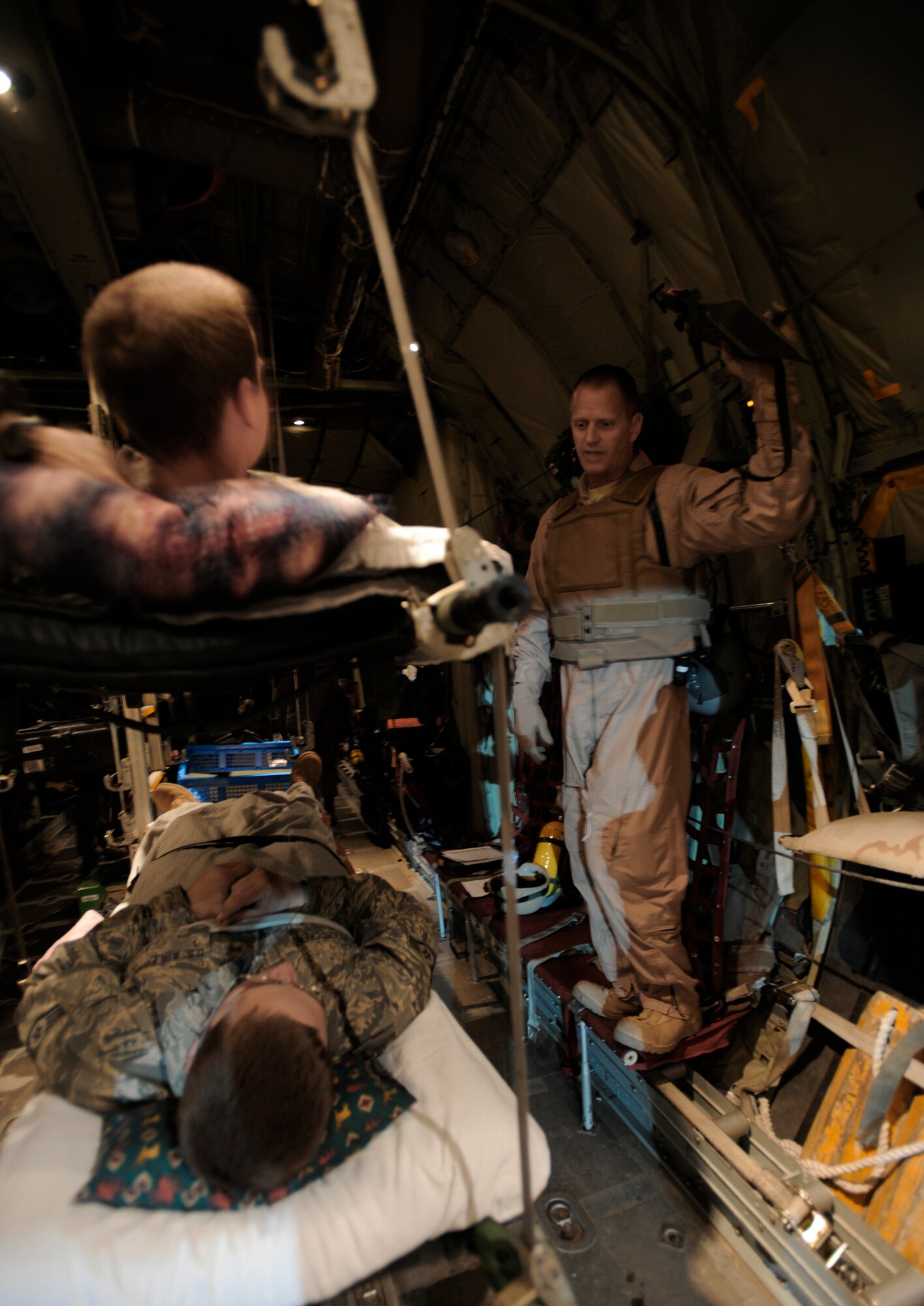 Maj. Scott Wilber gives a flight brief to patients aboard a C-130 Hercules during aeromedical operations April 23 over Southwest Asia. Major Wilber is a flight nurse from the 379th Expeditionary Aeromedical Evacuation Squadron. (U.S. Air Force photo/Staff Sgt. James L. Harper Jr.) 
