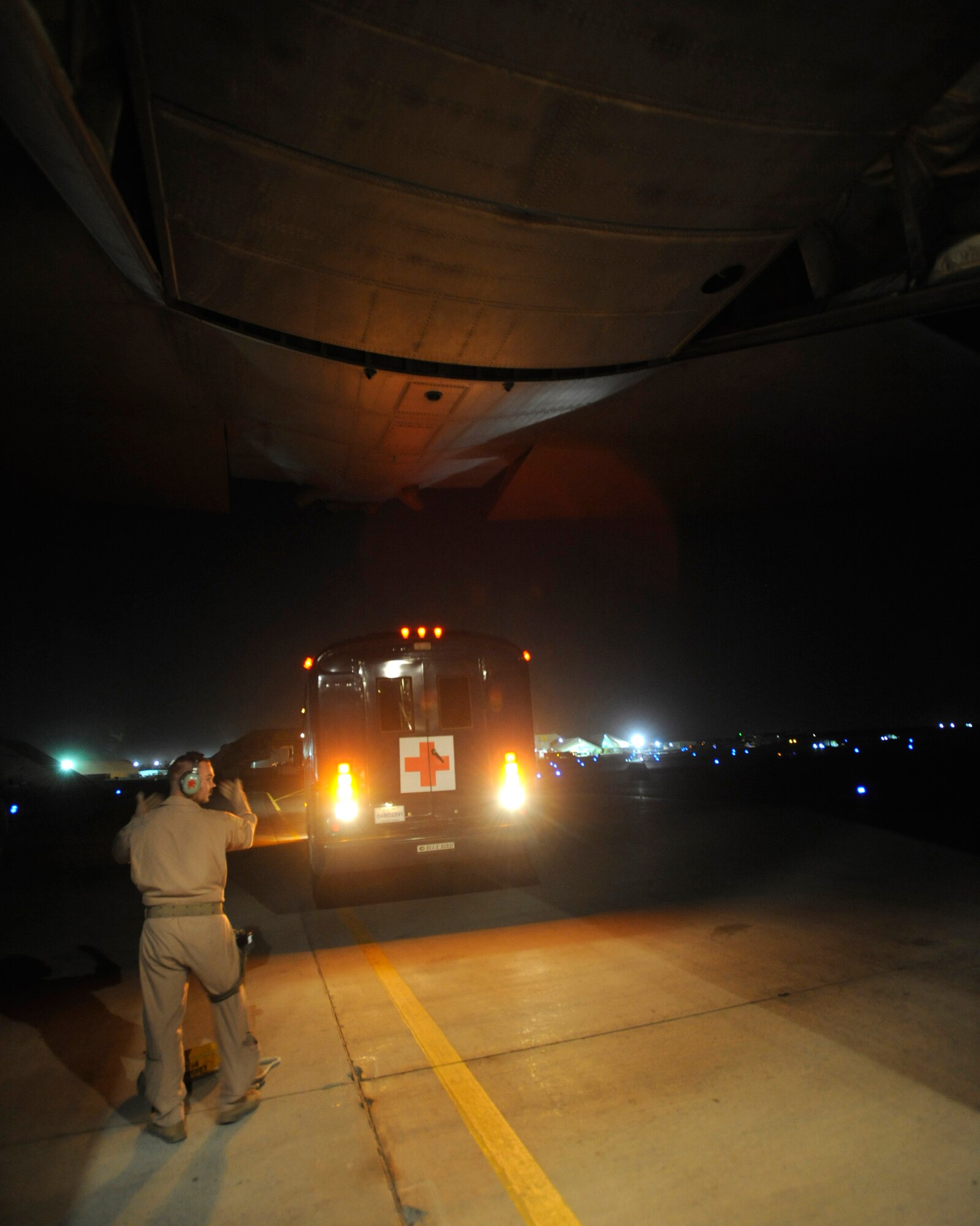 Staff Sgt. Josh Walker backs a medical bus to the rear of a C-130 Hercules to cross load patients during aeromedical operations April 23 over Southwest Asia. Sergeant Walker is a C-130 loadmaster from the 746th Expeditionary Airlift Squadron. (U.S. Air Force photo/Staff Sgt. James L. Harper Jr.) 
