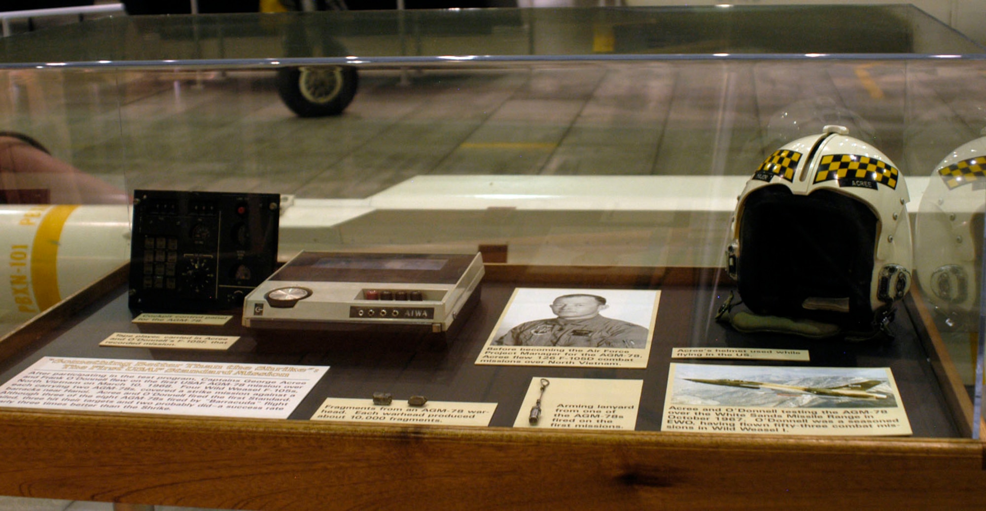 DAYTON, Ohio - Items in the First In, Last Out: WIld Weasels vs. SAMs exhibit: 1) Tape player, carried on Acree and O-Donnell's F-105, that recorded the mission. 2) Arming lanyards from AGM-78s fired on the first mission. 3) Acree's helmet used while flying in the U.S. 4) Fragments from an AGM-78 warhead. Each warhead produced 10,000 fragments. 5) Cockpit control panel for the AGM-78. Fp1-5G patch. (U.S. AIr Force photo)