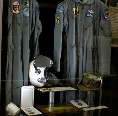DAYTON, Ohio - In the First In, Last Out: WIld Weasels vs. SAMs exhibit: 1) Capt. Fred Shannon's flight suit and "boonie hat" worn during his tour with the 13th Tactical Fighter Squadron at Korat in 1967. 2) The Air Force Cross awarded to Capt. Fred Shannon. 3) McInerney's K-2B flight suit and his custom-fitted Toptex 3BM helmet. Worn on the Aug. 11, 1967, mission, he continued to use the helmet until he retired in 1980. 4) Air Force Association award given to McInerney, who developed the very effective tactic of entering the target area 5-7 minutes ahead of the strike force to look for SAM sites. 5) Air Force Cross awarded to McInerney. (U.S. Air Force photo)