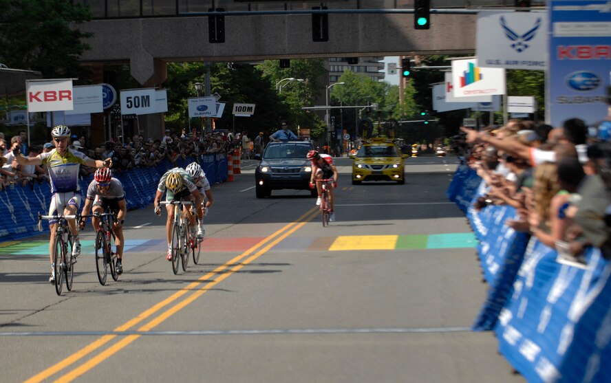Professional road bike racer Shawn Milne crosses the finish line first during the 2009 Air Force Cycling Classic in Crystal City, Va., May 31. Nearly 1,000 professional and amateur cyclists participated in the annual, two-day cycling event. (U.S. Air Force photo by Senior Airman Tim Chacon) 
