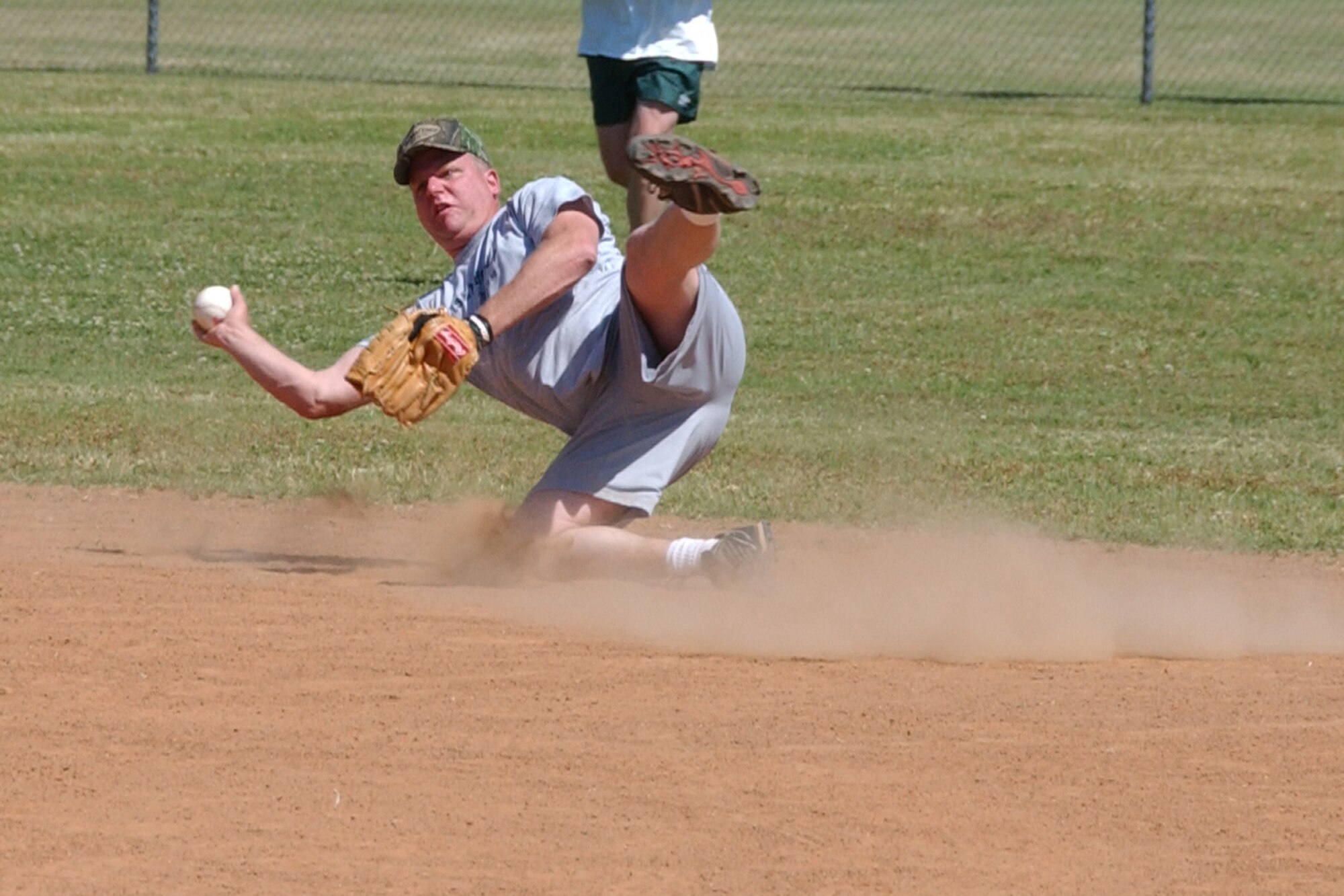 Master Sgt. Charles Daniels, 71st Security Forces Squadron, dives to make a play for a forced out at second base during the Senior Leadership Softball Classic May 29. (U.S. Air Force photo by Staff Sgt. Brian Hill).