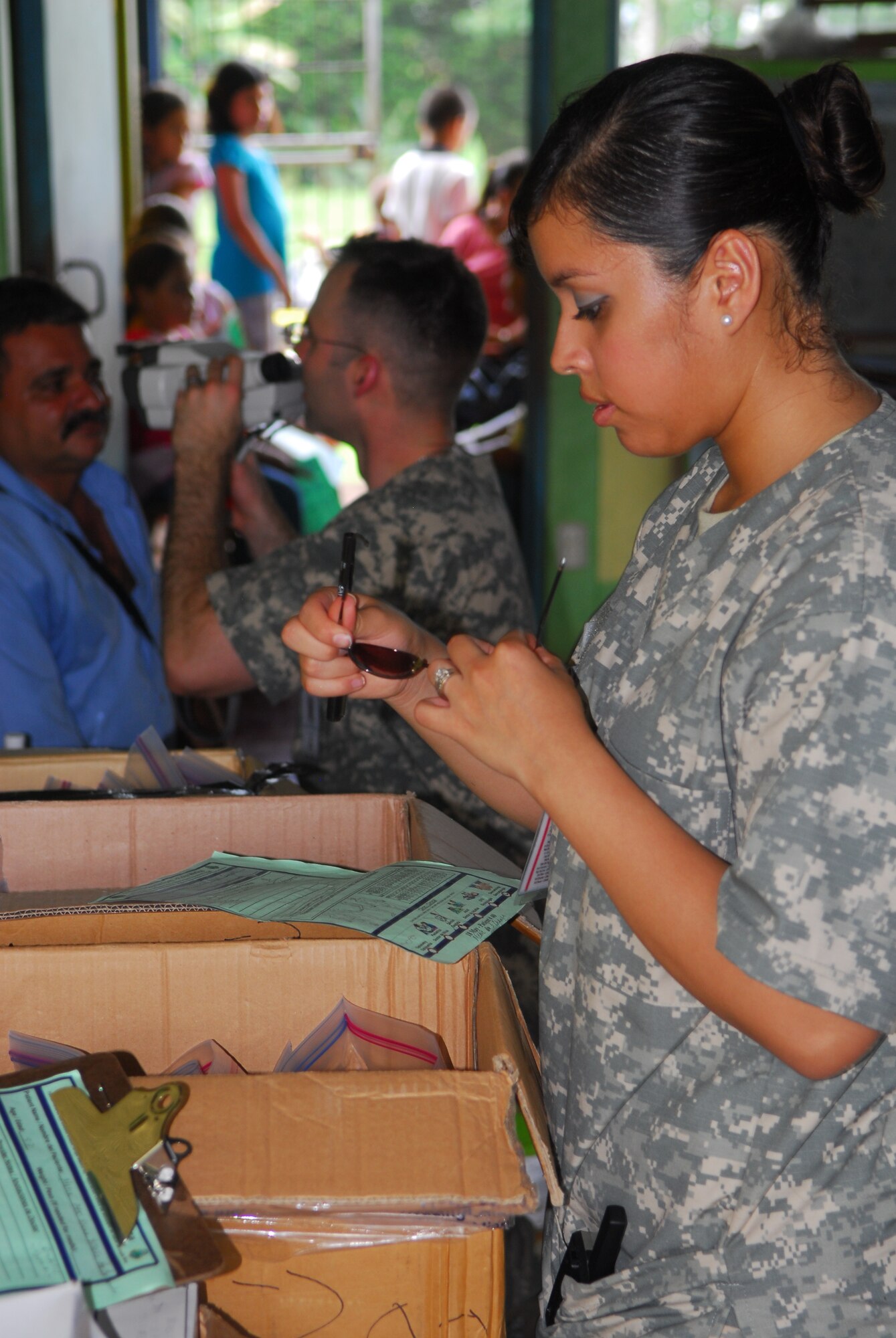 NORTHERN PROVINCE OF ALAJUELA, Costa Rica – Checking sizes and prescriptions, Senior Airman Maricella Estrada-Sarabia, a 30th Medical Operations Squadron aerospace medical services journeyman, helps Capt. Adam Klemens, a 30th MDOS optometrist, select glasses for a local resident here May 20. Medical personnel from the 30th Space Wing deployed to Costa Rica May 16 - 30 as part of a humanitarian effort with local Costa Rican physicians. Medical specialists from both countries provided medical care to residents who are rarely seen by physicians due to living in isolated areas. (U.S. Air Force photo/Airman 1st Class Steve Bauer) 