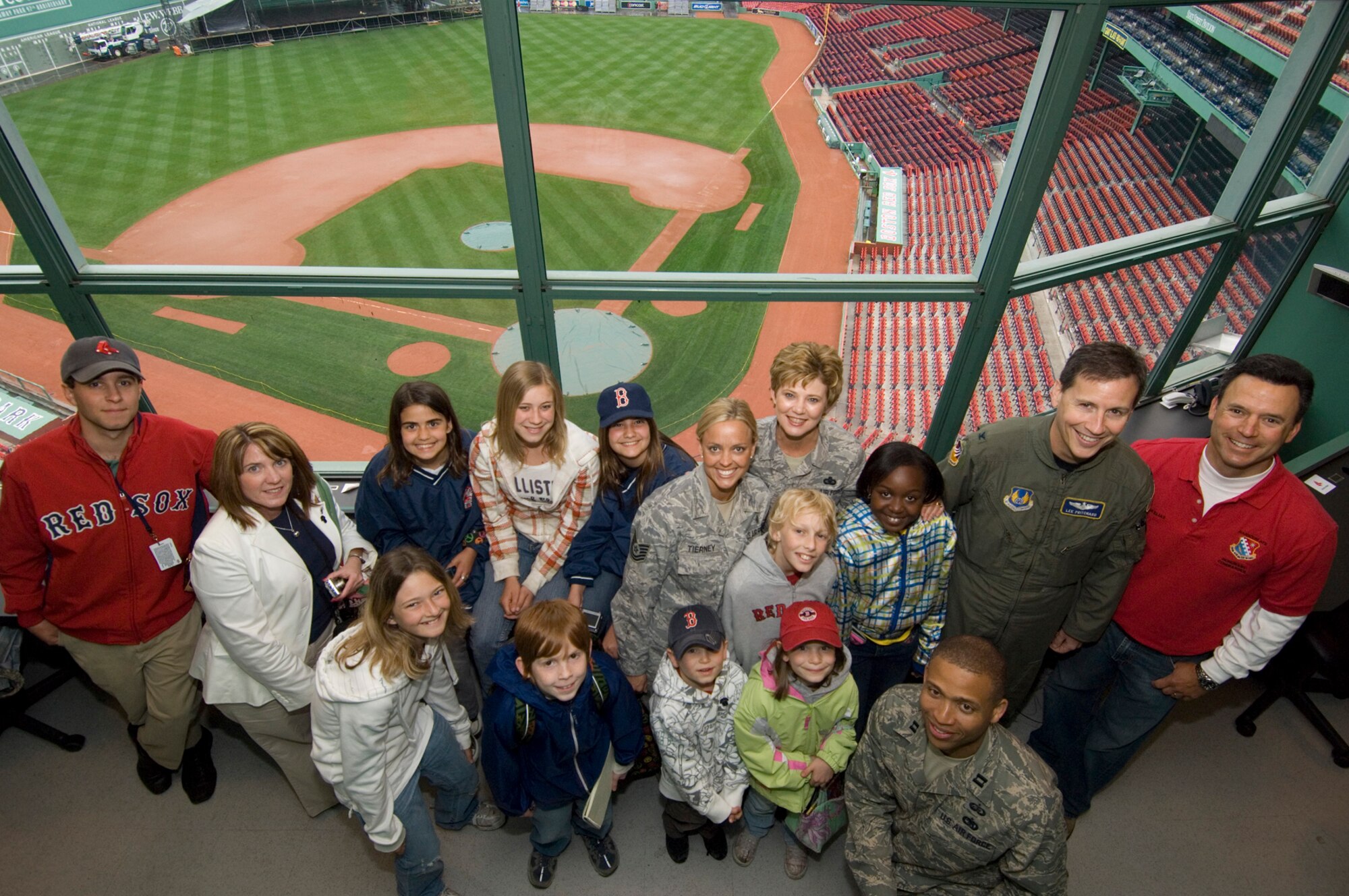 HANSCOM AIR FORCE BASE, Mass. – Jonathan Elias, 66th Air Base Wing honorary commander and anchorman for WBZ television in Boston, hosted a special tour of Fenway Park for some Hanscom children on May 27. Pictured in the Fenway Park press box during the tour are front row (left to right) Jordan Blide, Dylan Trayler, Nicholas and Abby Belko, Capt. Joe Green. Back row (left to right) Fenway Park staff member, Dorothy Febbi, Kayla Gonsalves, Kathryn Wilkes, Brenna Gonsalves, Tech. Sgt. Jennifer Tierney, Chief Master Sgt. Ginger Thompson, Tyler Tierney, Kayla John, Col. Lee Pritchard, Jonathan Elias. (U.S. Air Force photo by Rick Berry)