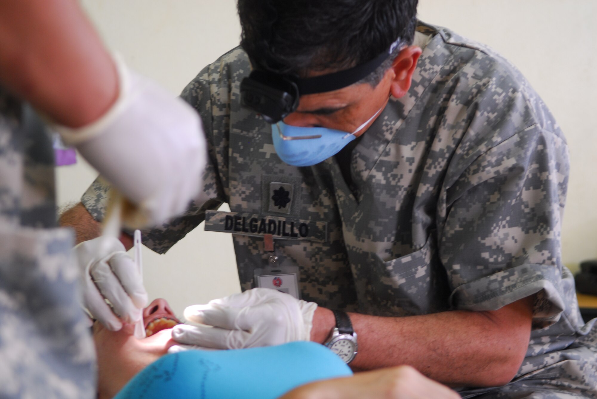 NORTHERN PROVINCE OF ALAJUELA, Costa Rica – Leaning in for a closer look, Lt. Col. Guy Delgadillo, the 30th Medical Operations Squadron dental flight commander, inspects the teeth of a local resident here May 21. Medical personnel from the 30th Space Wing deployed to Costa Rica May 16 - 30 as part of a humanitarian effort with local Costa Rican physicians. Medical specialists from both countries provided medical care to residents who are rarely seen by physicians due to living in isolated areas.(U.S. Air Force photo/Airman 1st Class Steve Bauer) 
