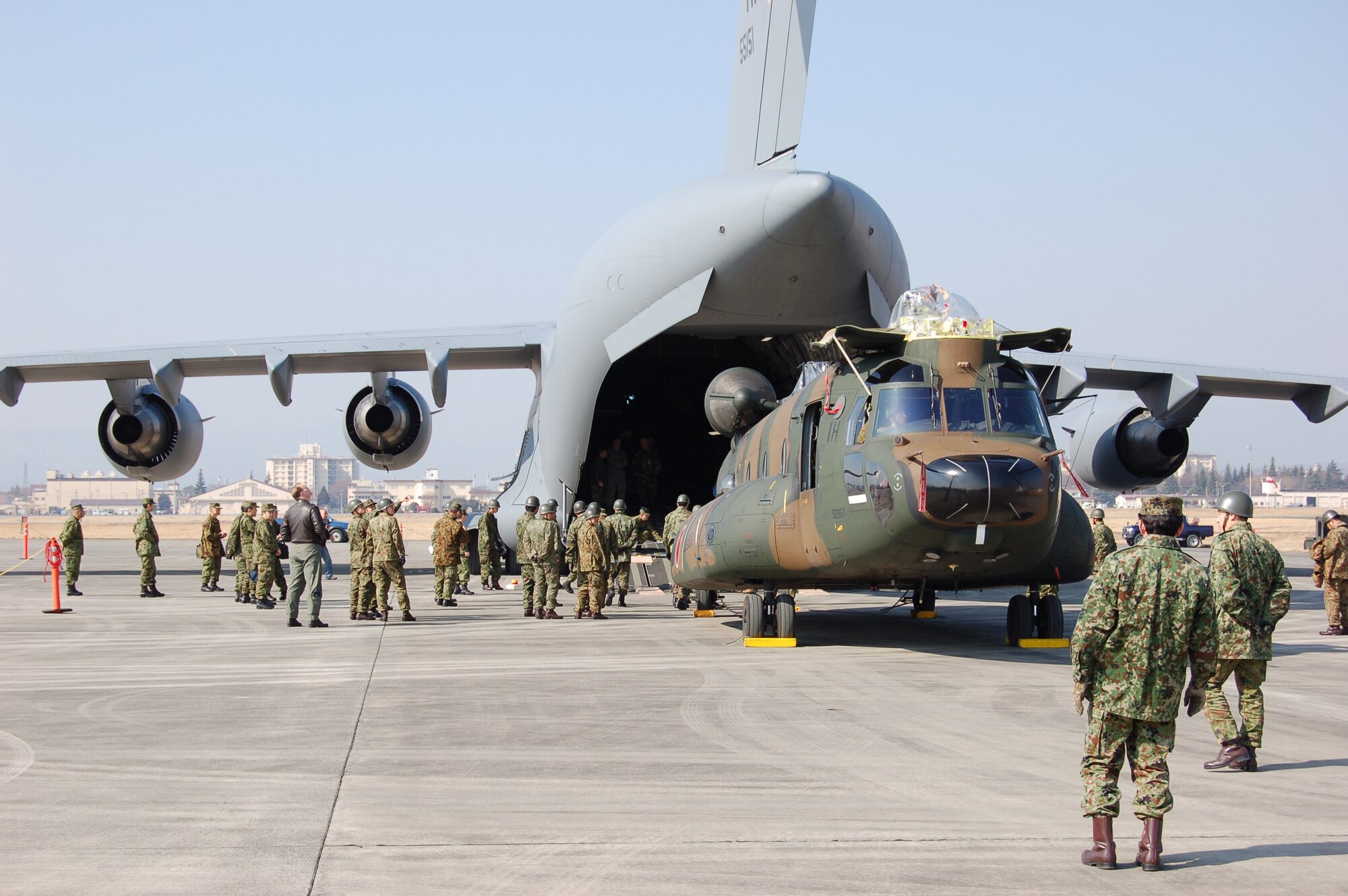 The 730th Air Mobility Squadron at Yokota Air Base, Japan, assists in the first-time loading of a Japan Ground Self Defense Force CH-47J Chinook helicopter on to a C-17A Globemaster III Feb. 23, 2008, as part of the 2008 Pacific Global Air Mobility Seminar.  It was also the first time a Japanese aircraft was loaded into another nation's aircraft. The CH-47J is assigned to the 1st Helicopter Brigade at JGSDF Camp Kisarazu in Kisarazu City, Chiba Prefecture, and the C-17 is assigned to the 535th Airlift Squadron at Hickam Air Force Base, Hawaii. (U.S. Air Force photo/Osakabe Yasuo)