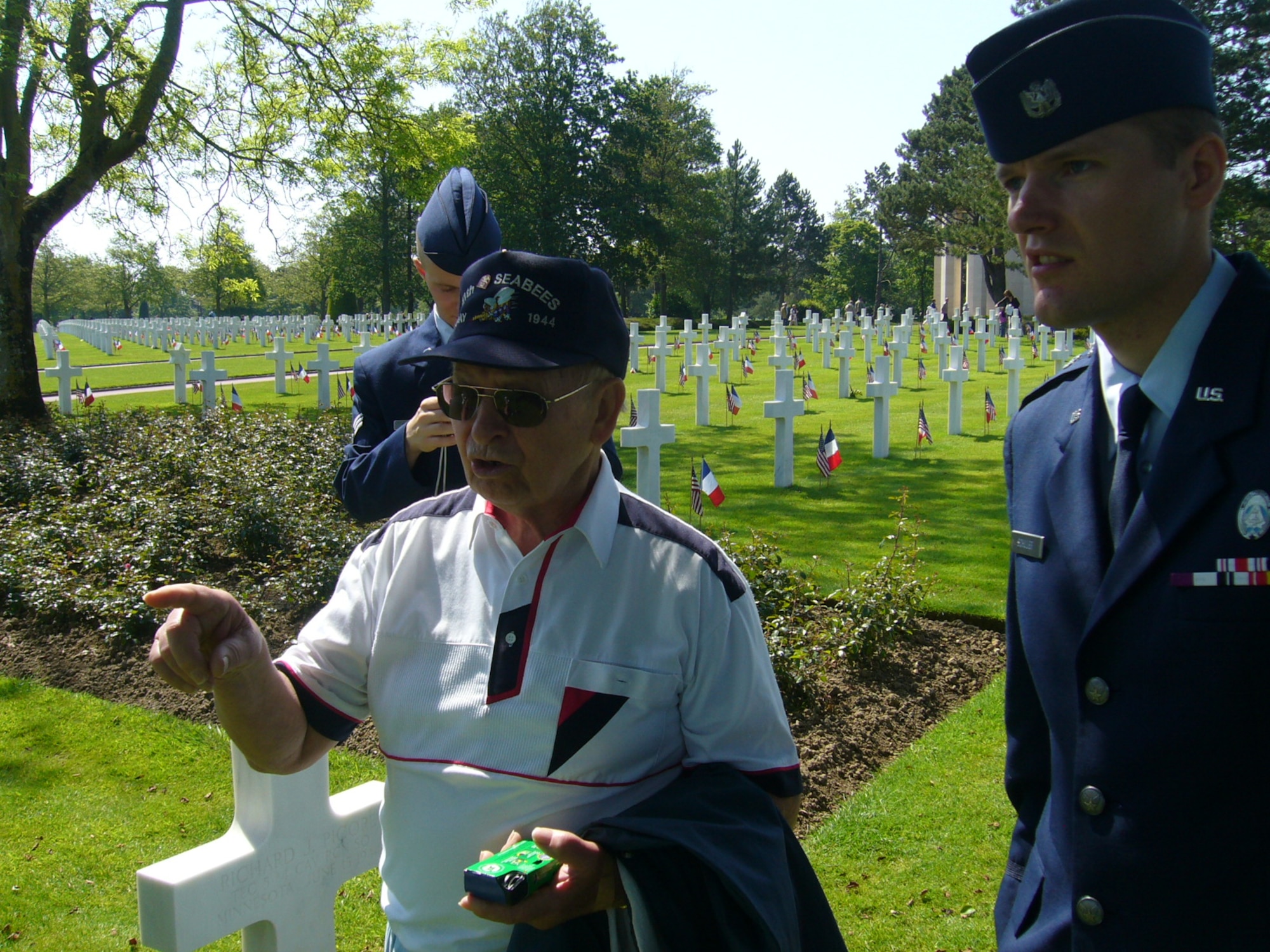 NORMANDY, France – First Lt. Frank Schuler, Civil Air Patrol Spangdahlem Cadet Squadron NHQ-OS-126, talks with Bill Rossvlet, CAP, while the two walk through the Normandy American Cemetery at Omaha Beach after attending a Memorial Day Ceremony there May 24, 2009. Mr. Rossvlet landed in Normandy June 7, 1944, D-Day plus one. (Courtesy photo)