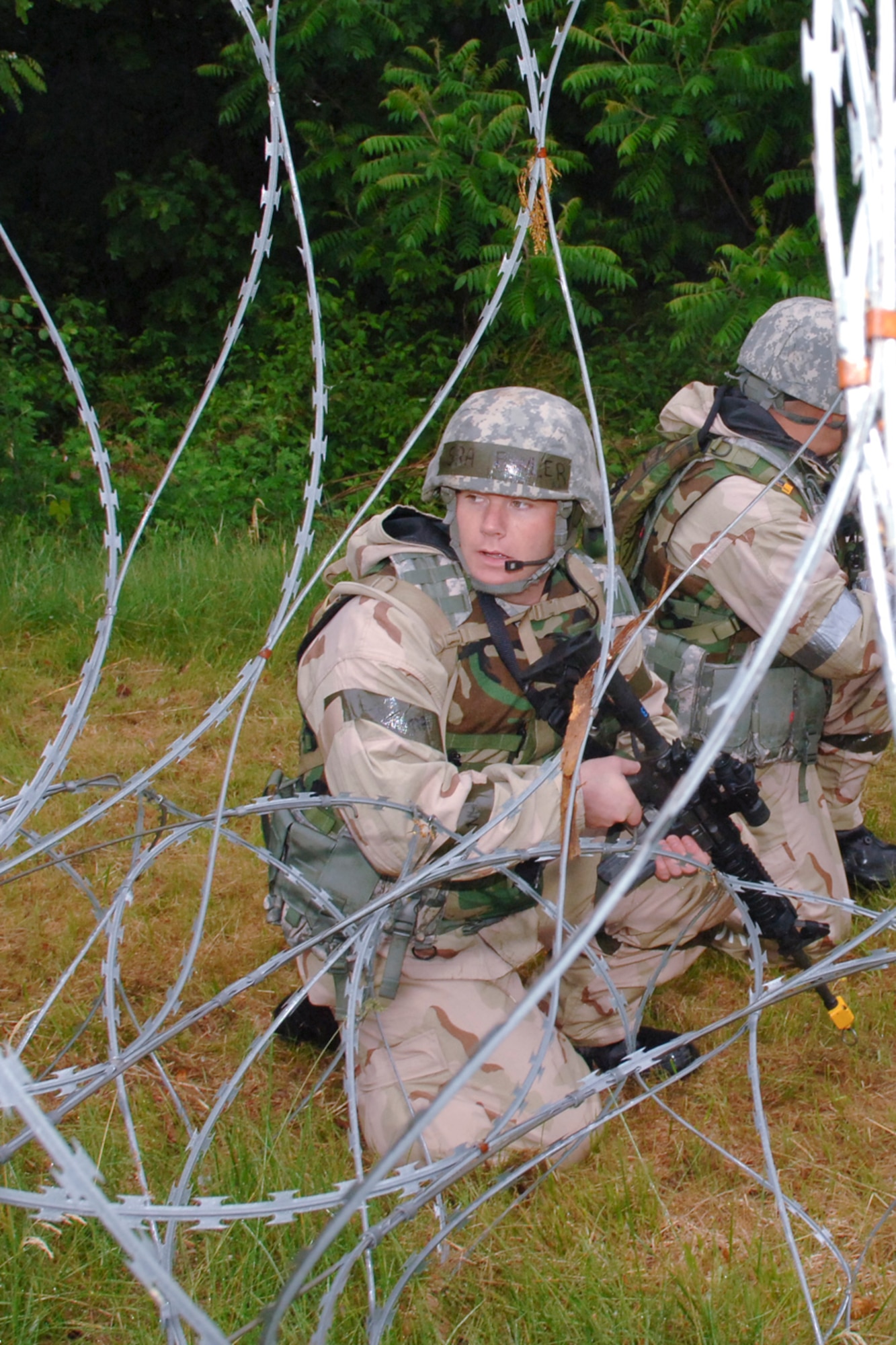 HANSCOM AIR FORCE BASE, Mass. –Senior Airman Timothy Fowler, 66th Security Forces Squadron searches outside the wire for an enemy combatant following a simulated attack at Camp Patriot during the May 26 to 29, Base Readiness Exercise. (U.S. Air Force photo by Rick Berry)