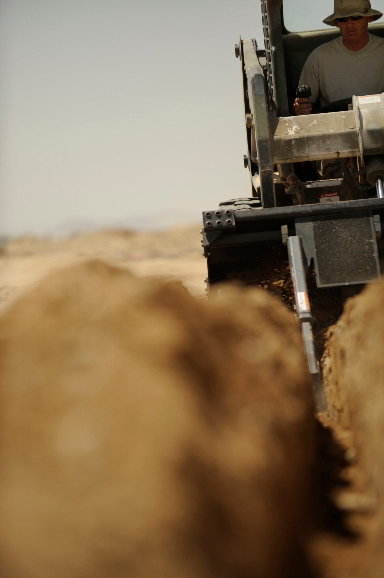U.S. Air Force Staff Sgt. matt Byrd, a power production technician, 72nd Expeditionary Air Control Squadron, 451st Air Expeditionary Group, Kandahar Air Field, Afghanistan, prepares a ditch to lay power cables on May 17, 2009, in support of Operation Enduring Freedom. The Air Control Squadron is being built from the ground up to replace an outdated system being used currently at Kandahar Air Field.  (U.S. Air Force photo by Staff Sgt. James L. Harper Jr.)Released