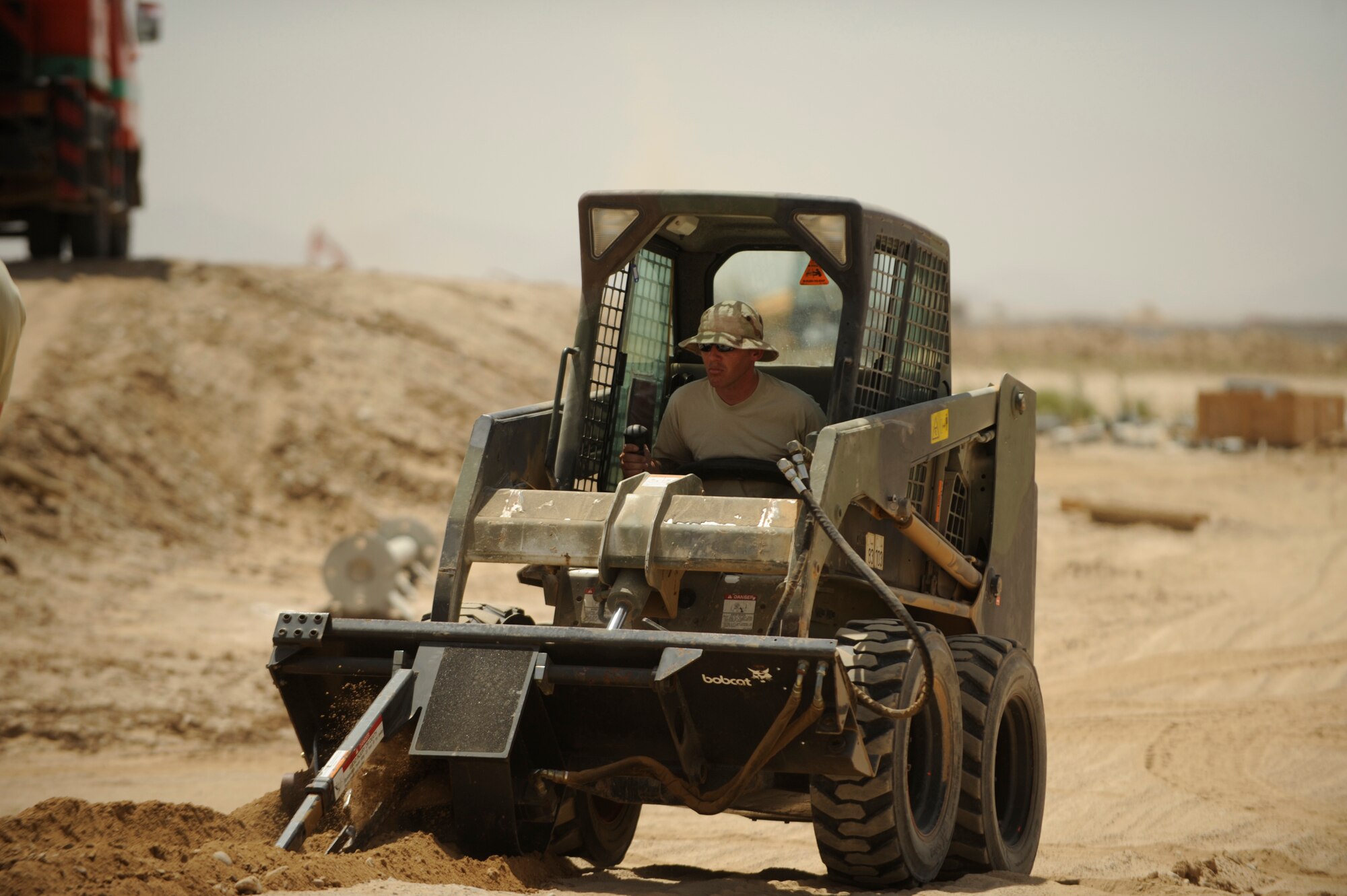 U.S. Air Force Staff Sgt. matt Byrd, a power production technician, 72nd Expeditionary Air Control Squadron, 451st Air Expeditionary Group, Kandahar Air Field, Afghanistan, prepares a ditch to lay power cables on May 17, 2009, in support of Operation Enduring Freedom. The Air Control Squadron is being built from the ground up to replace an outdated system being used currently at Kandahar Air Field.  (U.S. Air Force photo by Staff Sgt. James L. Harper Jr.)Released