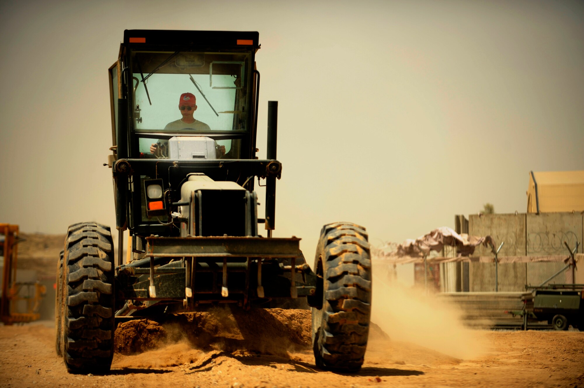 U.S. Air Force Staff Sgt. Derek Ross, engineer, 819th Expeditionary Red Horse Squadron operates a grader at Kandahar Airfield, Afghanistan, on May 7, 2009, in support of Operation Enduring Freedom.  Red Horse is assisting the 451st Air Expeditionary Group with air field expansion to accommodate the influx of aircraft required to support the surge in Afghanistan. (U.S. Air Force photo by Staff Sgt. James L. Harper Jr.)Released