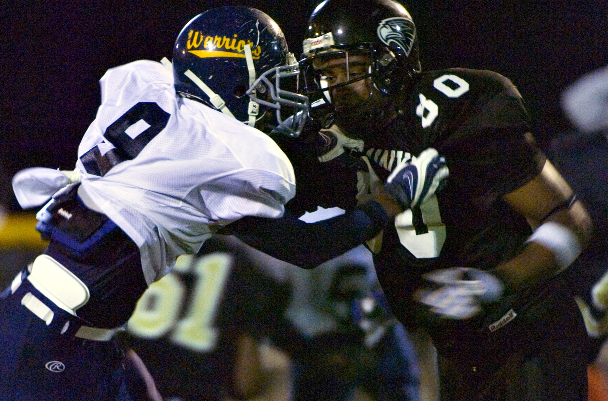 YOKOSUKA NAVAL BASE, Japan -- Yokota Warriors' defensive end Frederick Guild fends off the block of a Yokosuka tight end during the fourth quarter of Yokosuka's 41-12 win over the Warriors May 30 in U.S. Forces Japan-American Football League action. The Seahawks improved to 3-0 on the season, while Yokota fell to 0-3. The Warriors' final two home games at Bonk Field are set for 5 p.m. June 6 vs. Misawa and 4 p.m. June 27 vs. Kadena. (U.S. Air Force photo/Master Sgt. Matt Summers)