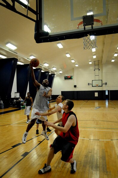 MISAWA AIR BASE, Japan -- Derreck Curtis drives past Douglas Warner for a lay-up during a 3-on-3 basketball tournament at the Potter Fitness Center May 27, 2009. Curtis' team finished the tournament in first place. (U.S. Air Force photo by Senior Airman Jamal D. Sutter)