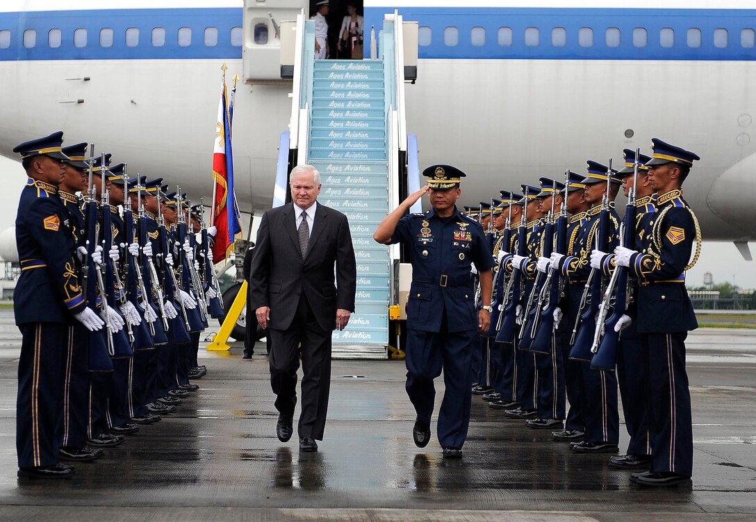 Philippine Air Force Commanding General Lt. Gen. Oscar Ravena, right, escorts U.S. Defense Secretary Robert M. Gates, left, past an honor guard upon Gates' arrival in Manila, Philippines, June 1, 2009. Gates is in the Philippines on a one-day visit to discuss bilateral issues concerning security and counter-terrorism.