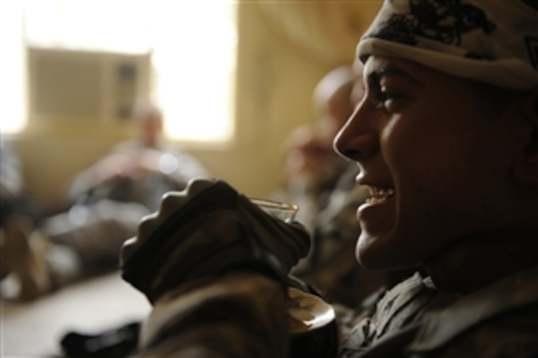 U.S. Army Cpl. Alan Aerts, with 2nd Battalion, 5th Cavalry Regiment, 1st Brigade Combat Team, 1st Cavalry Division, drinks chi and rests before continuing on a dismounted patrol outside of Joint Security Station Ur, Iraq, on May 22, 2009.  The purpose of the patrol is to show a strong Army presence in this area of operation.  DoD photo by Spc. Joshua E. Powell, U.S. Army.  (Released)